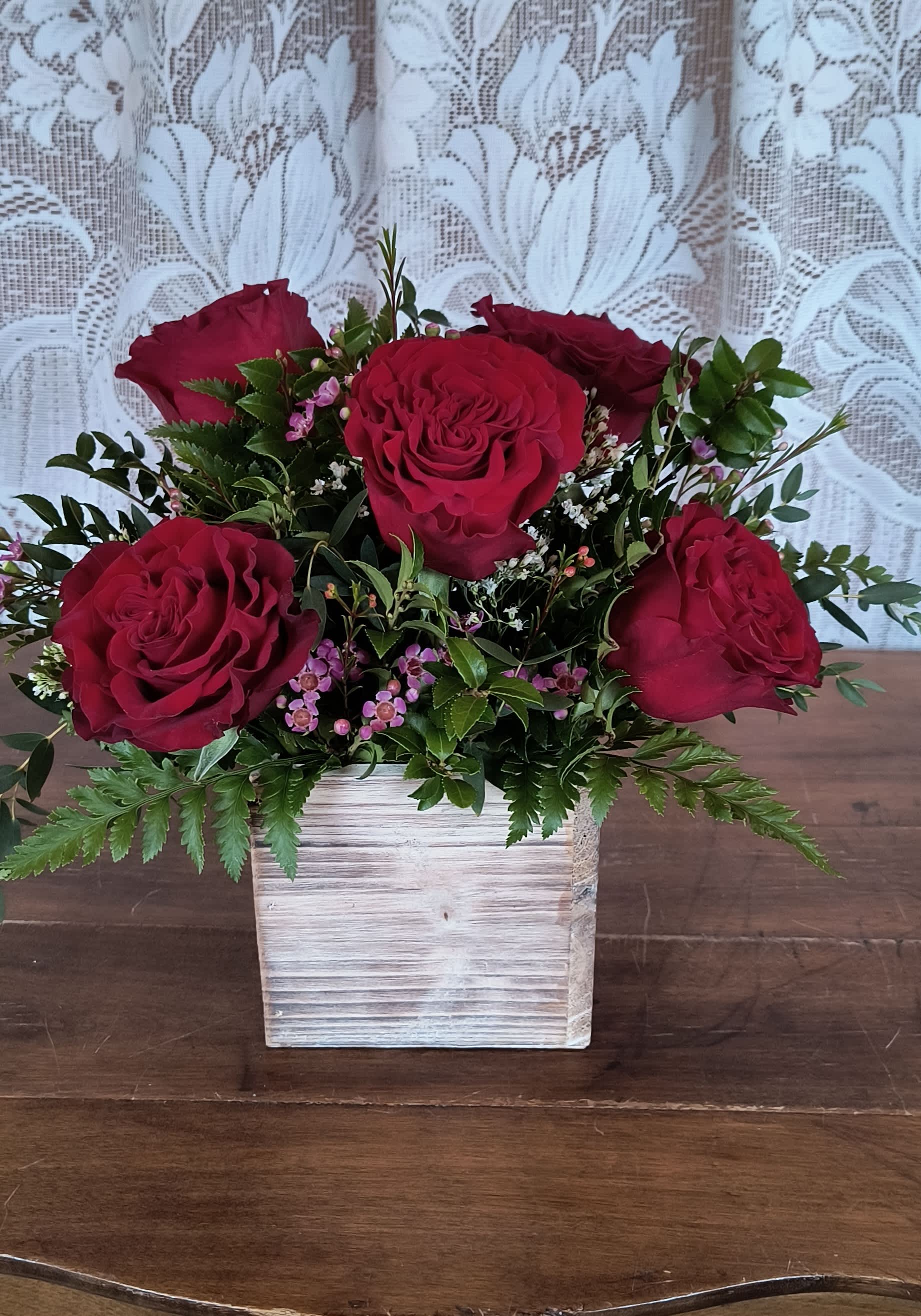 Luv U  - Romantic red roses and wax flower arranged in a woodland planter box prefect for and desk or end table.