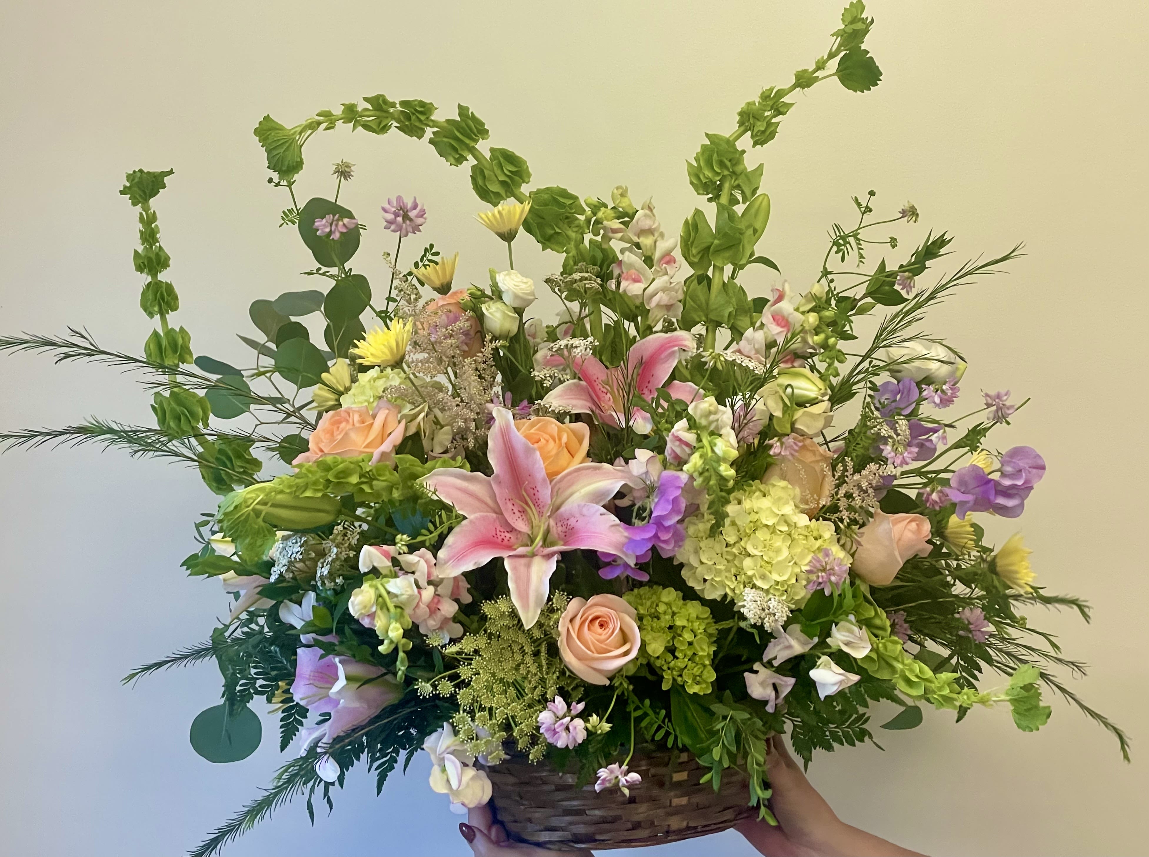 Va Va Bloom by Lotherington's - Turn up the heat with the vivacious large basket bouquet. This arrangement includes roses, carnations, belles of Ireland, stock, lilies, and hydrangea. This is the perfect gift for someone's birthday or any celebratory occasion.