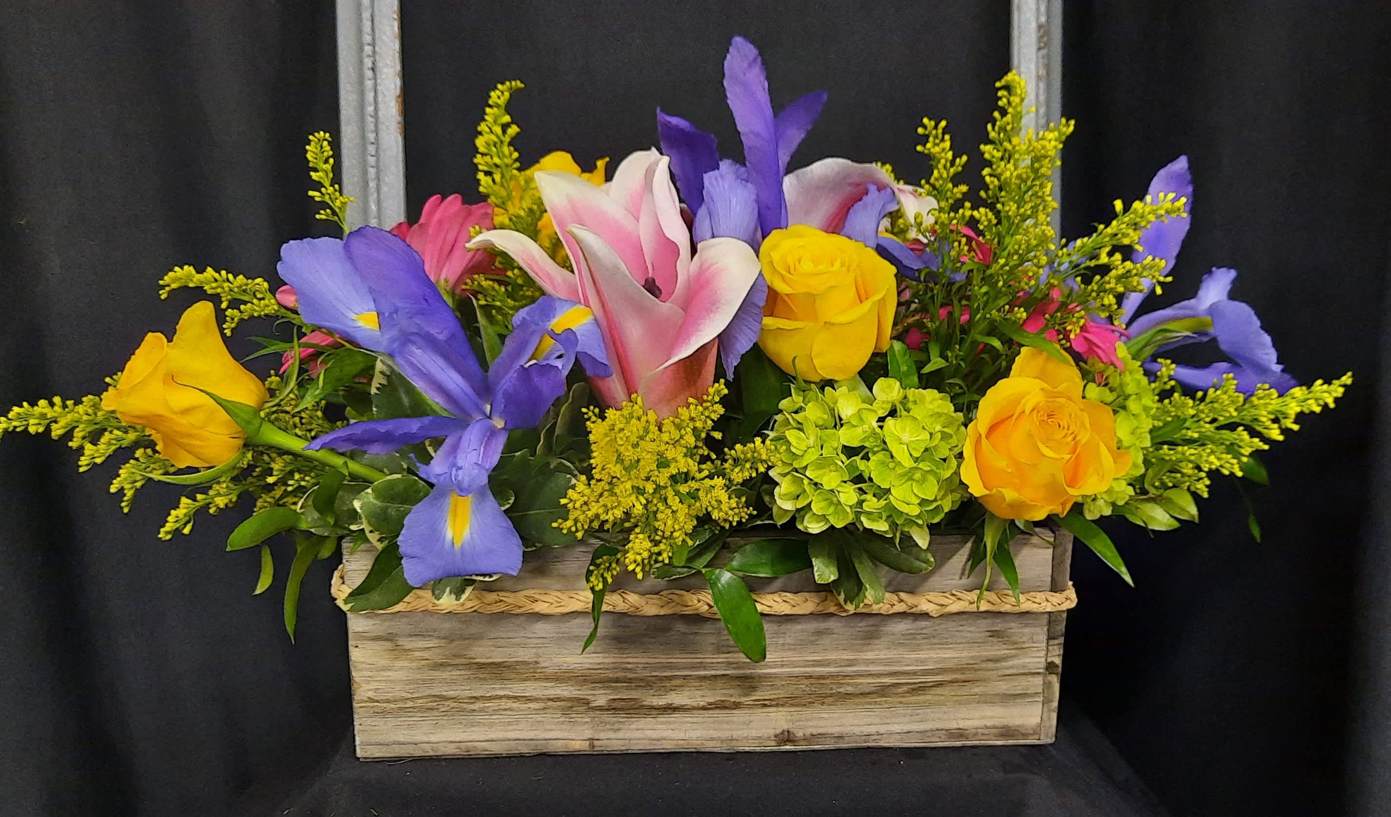 Flower Box of Spring - This adorable wooden box is filled with bright spring blooms- lilies, iris, roses, gerbera daisies, hydrangea.  Perfect as a centerpiece for your table or to bring the outdoors in. 