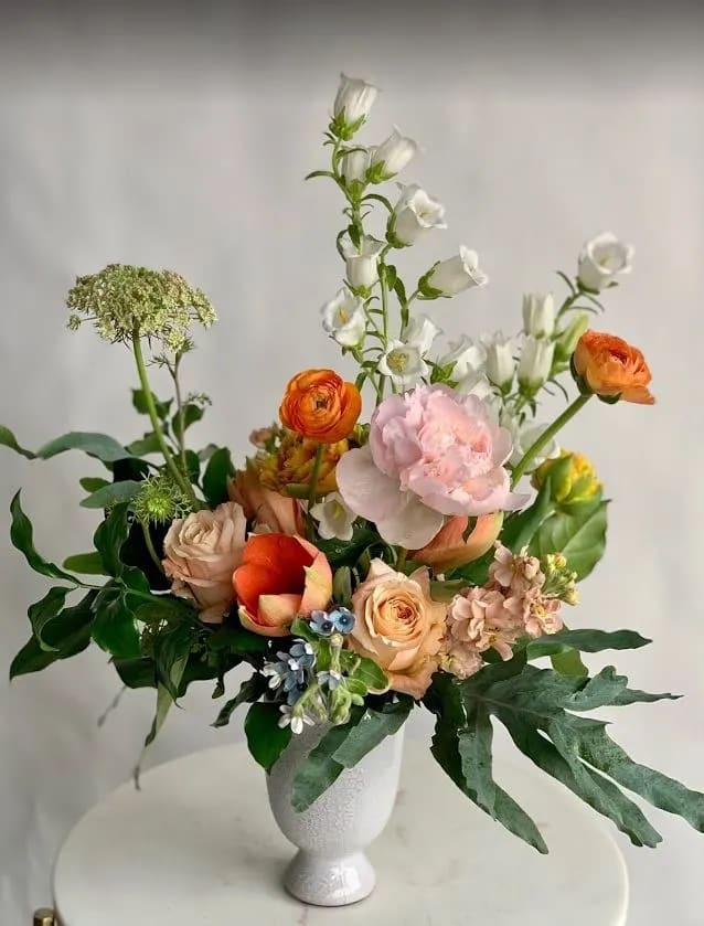 Spring Fling - All of our favorite blooms in one vase.  Beautifully designed with our freshest seasonal offerings in lovely shades of apricot, blush and white with pops of orange.    