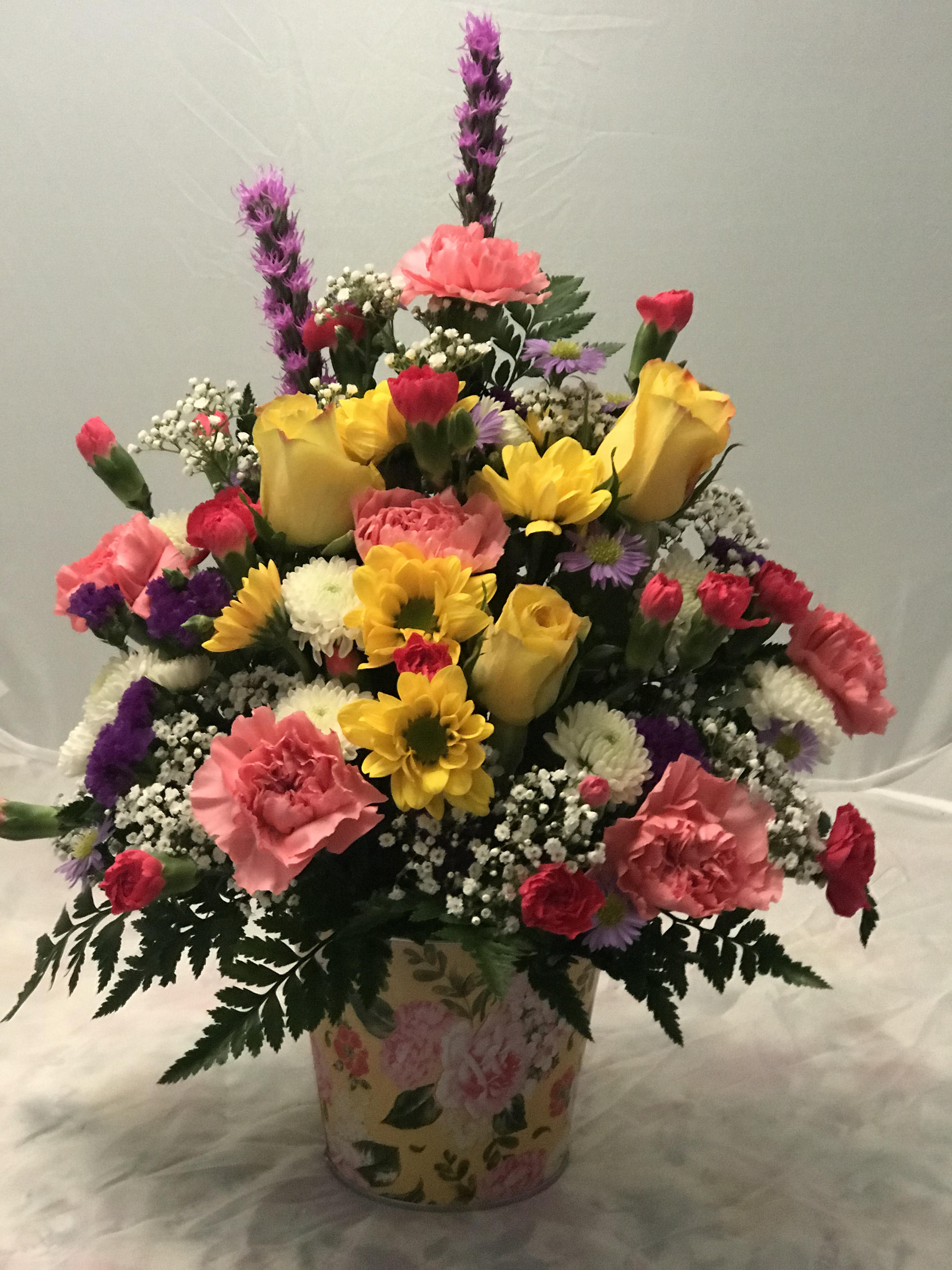 Brighter Days  -  Wish them well and remind them there are brighter days ahead! From yellow roses to pink carns  this rainbow of blooms will brighten their space - and their spirits. *Colors may vary *ARRANGEMENT IS ONE-SIDED*
