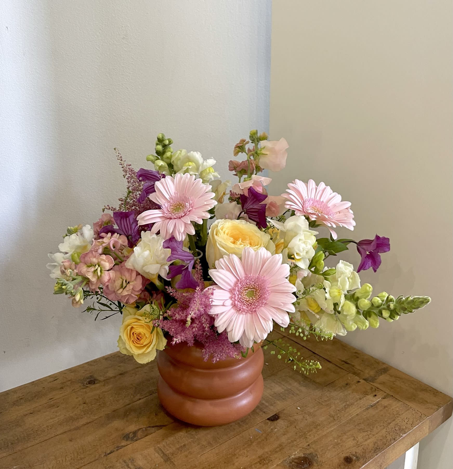 Garden Party - A whimsical summer blooms arrangement with gerber daisies, stock, snapdragon, astilbe, and garden roses. 