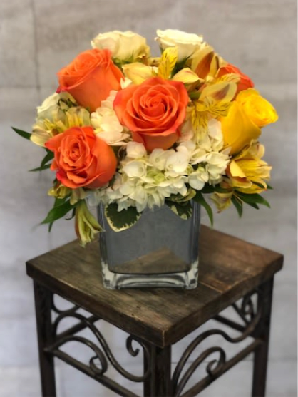 Beautiful Sunrise - A soft, elegant arrangement featuring orange and yellow roses, white hydrangea, and creamy alstroemeria, accented with fresh green foliage. The color palette is warm and gentle, creating a cheerful yet refined look.  