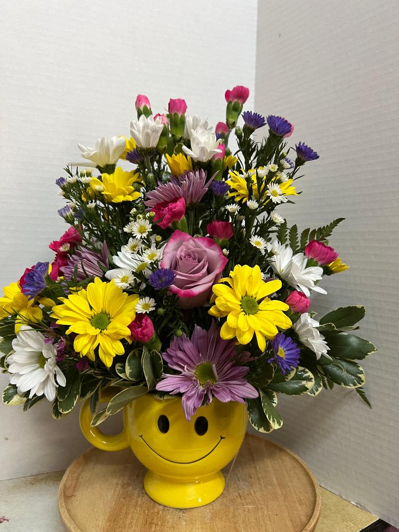 COLOR ME HAPPY - COLORFUL MIXED FLOWER ARRANGEMENT IN A SMILEY FACE MUG