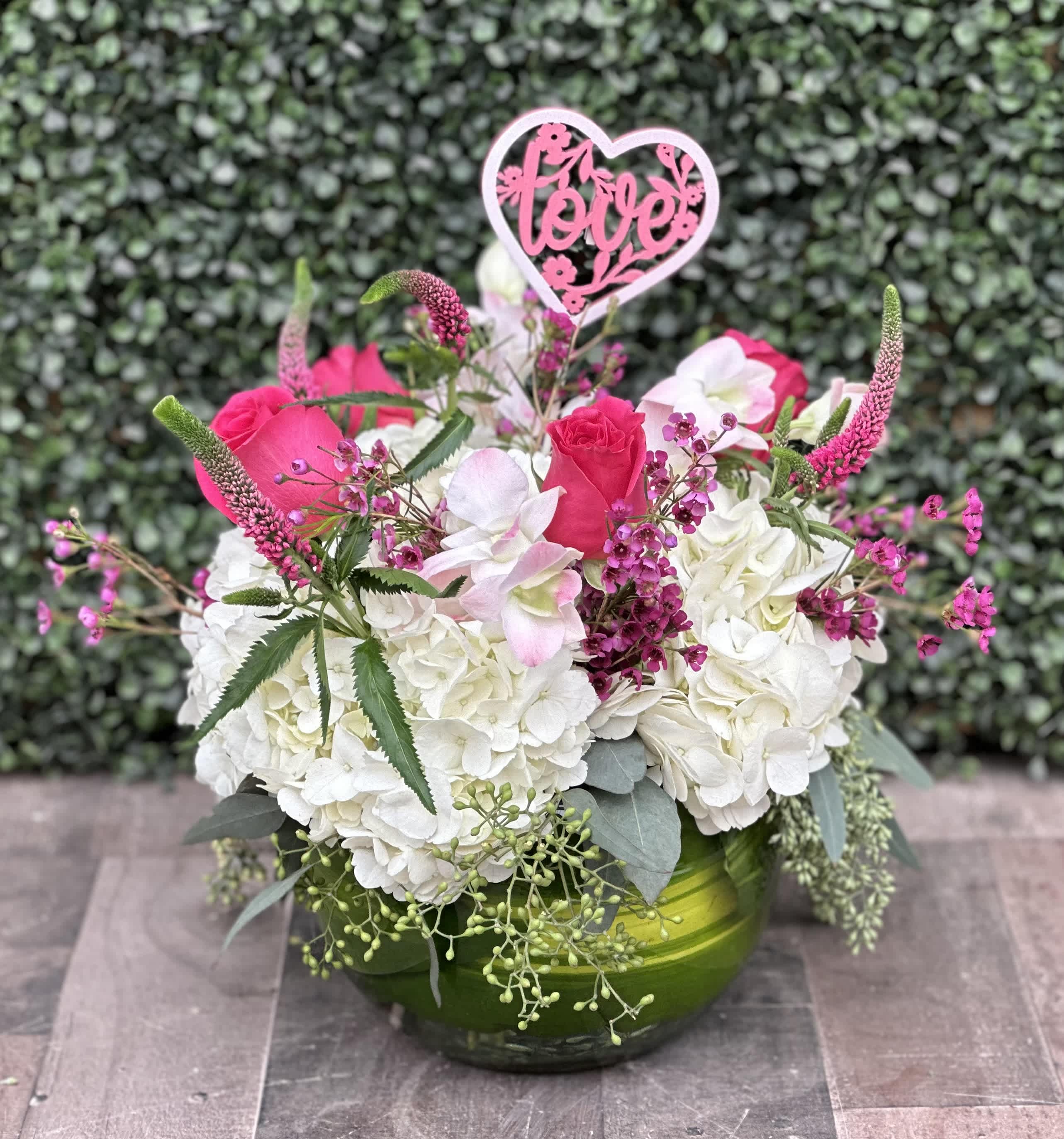 VALENTINE'S BUBBLES - This Valentine's themed arrangement comes designed in a bubble bowl with hydrangeas, roses, wax flower, veronica and assorted greens. 