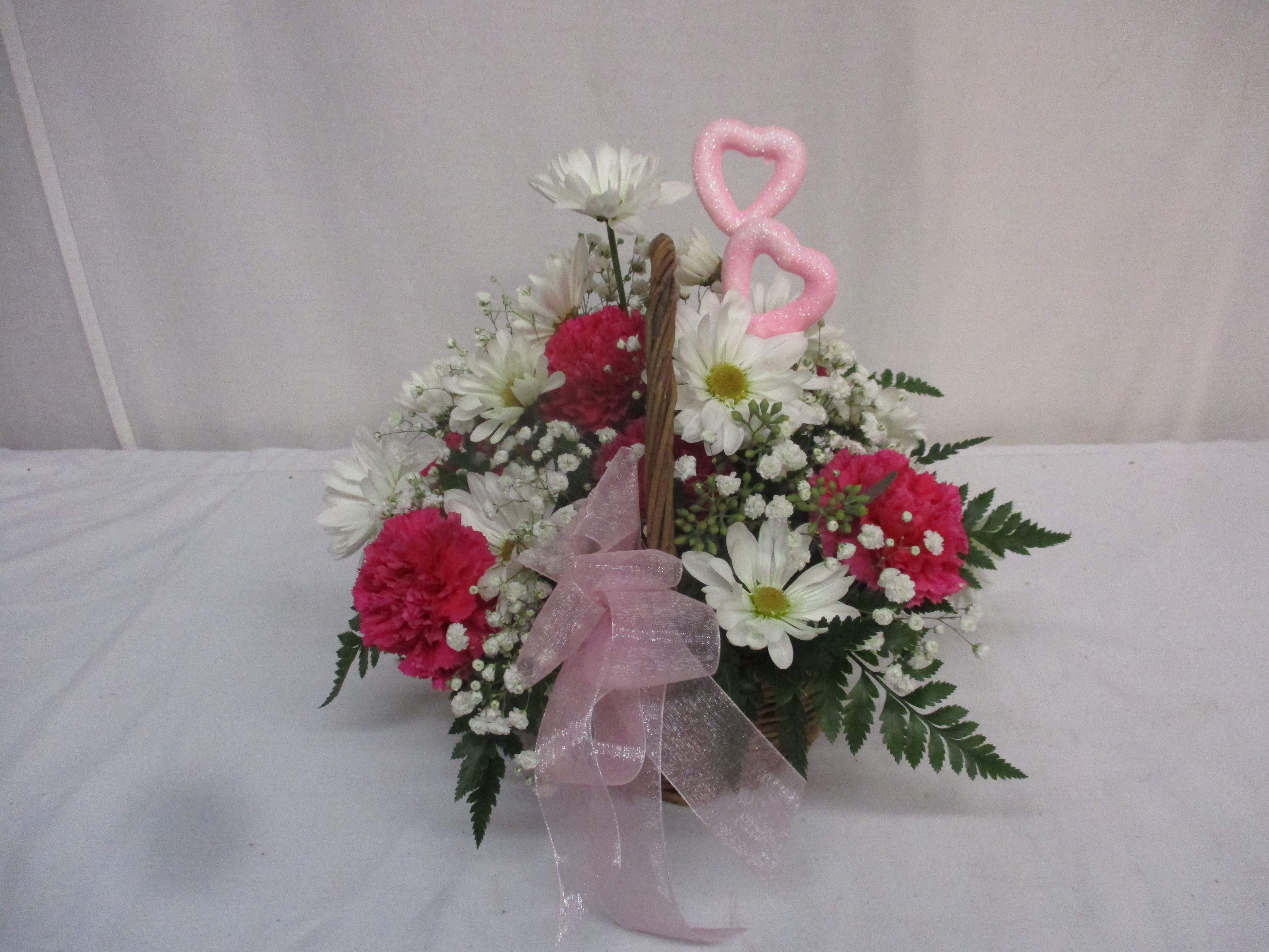 All In Love Basket - This basket of fresh pink and white flowers is a perfect way to show someone that they are in your thoughts. The glittered hearts adorning the arrangement add just a touch of love to the setting.