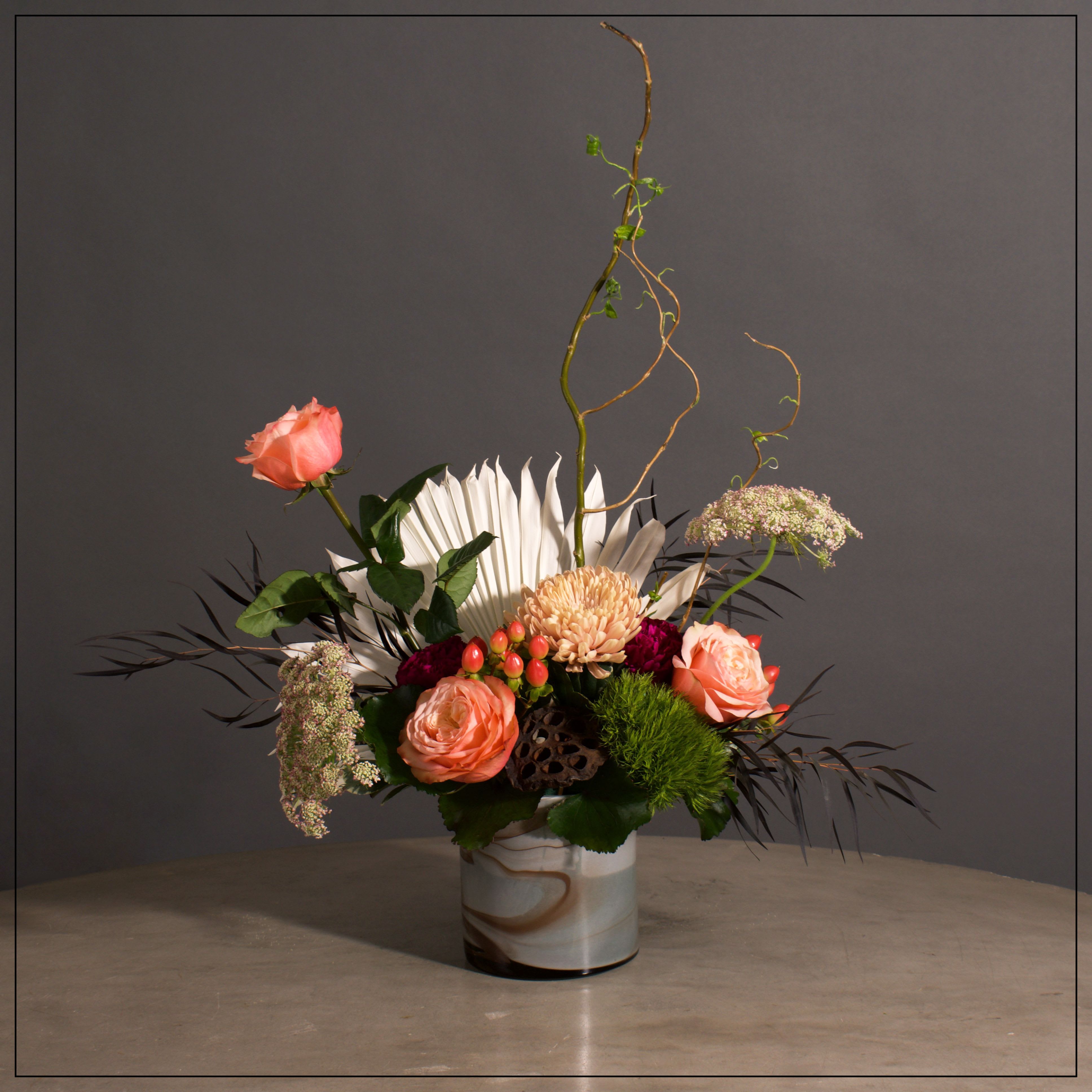 Carmel - Roses, Cremones, Carnations and various fillers ina cute chocolate marbled Glass Vase.  Approximately 12" W x 19" H