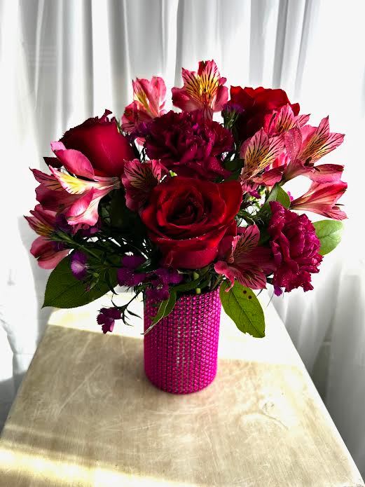 Lil Bit Glam - Alstromeria, roses, and carnations gathered in a small vase wrapped with hot pink shiny wrap.