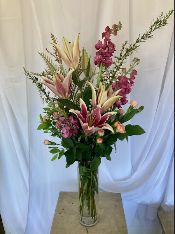 Love You More!!! - Sweet lilies, pink stock in a tall slender vase. Such a lovely arrangement yet so soft and sweet! 