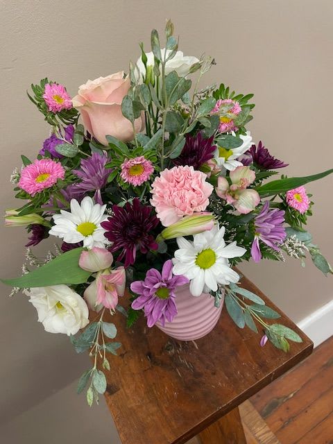 Seasonal Mixed Container - Our mixed flower containers are overflowing with a variety of flowers and colors. We have a huge selection of ceramic pots, metal pots, or wicker baskets.  Our designers are talented at creating a unique and long-lasting bouquet.