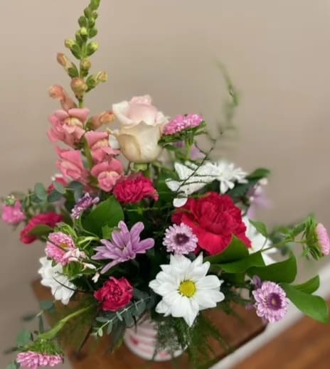 Valentine's Designer's Choice Pot in Pinks - Let our talented team create a bouquet in one of our Valentine's Day pots. A bouquet filled with shades of pinks, whites, and lavender and a variety of blooms. 