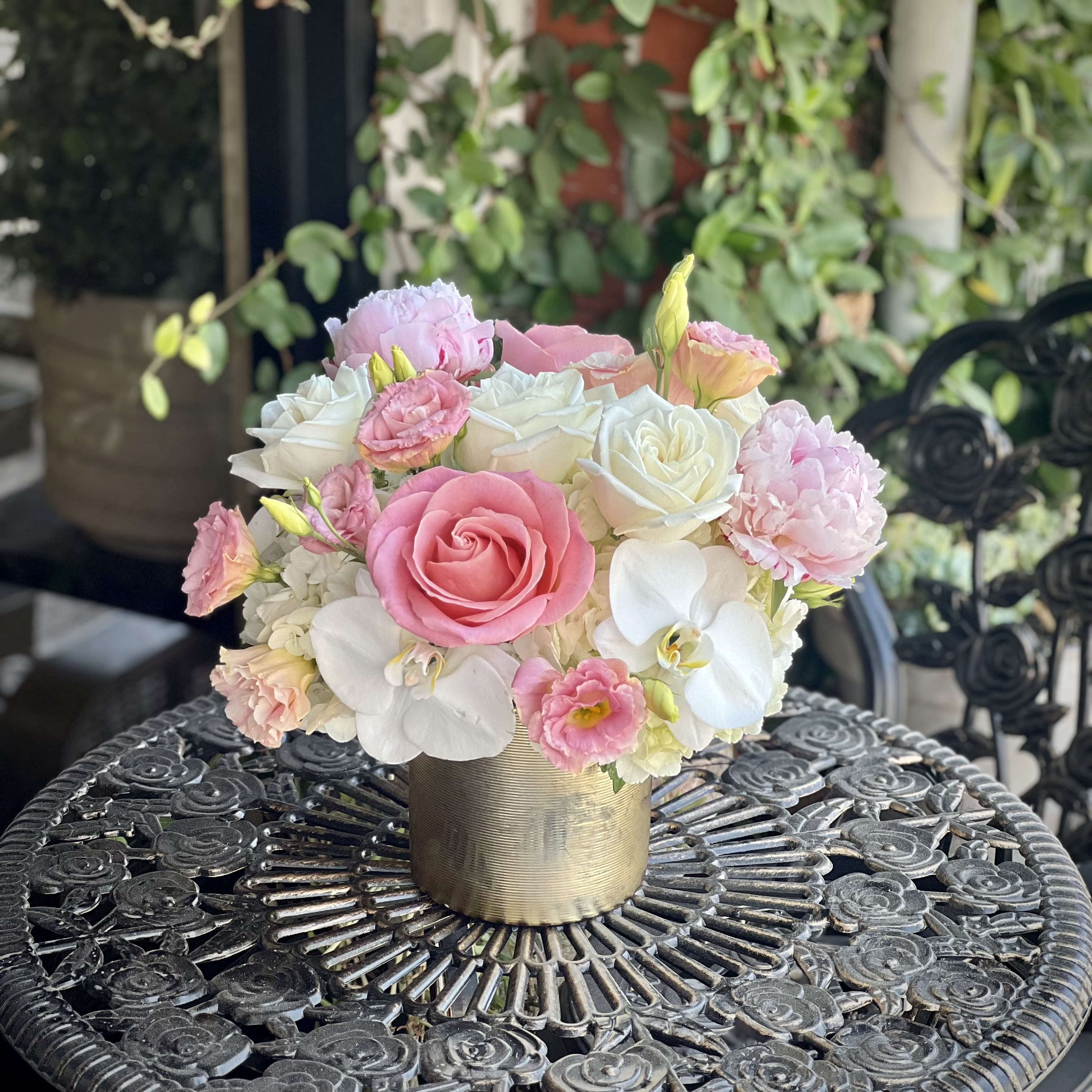 Forever Mine (Peonies!) - Soft, sweet, and effortlessly romantic—Forever Mine is a charming blend of blush and white blooms in a luxe golden vase. Featuring roses, lisianthus, peonies, hydrangea, and elegant white phalaenopsis orchids, this compact arrangement is perfect for anniversaries, heartfelt gestures, or simply saying “I adore you.” Classic with a modern twist, it's beauty that speaks volumes. Arrangement approximately measures 15" wide and 12" tall with flowers.