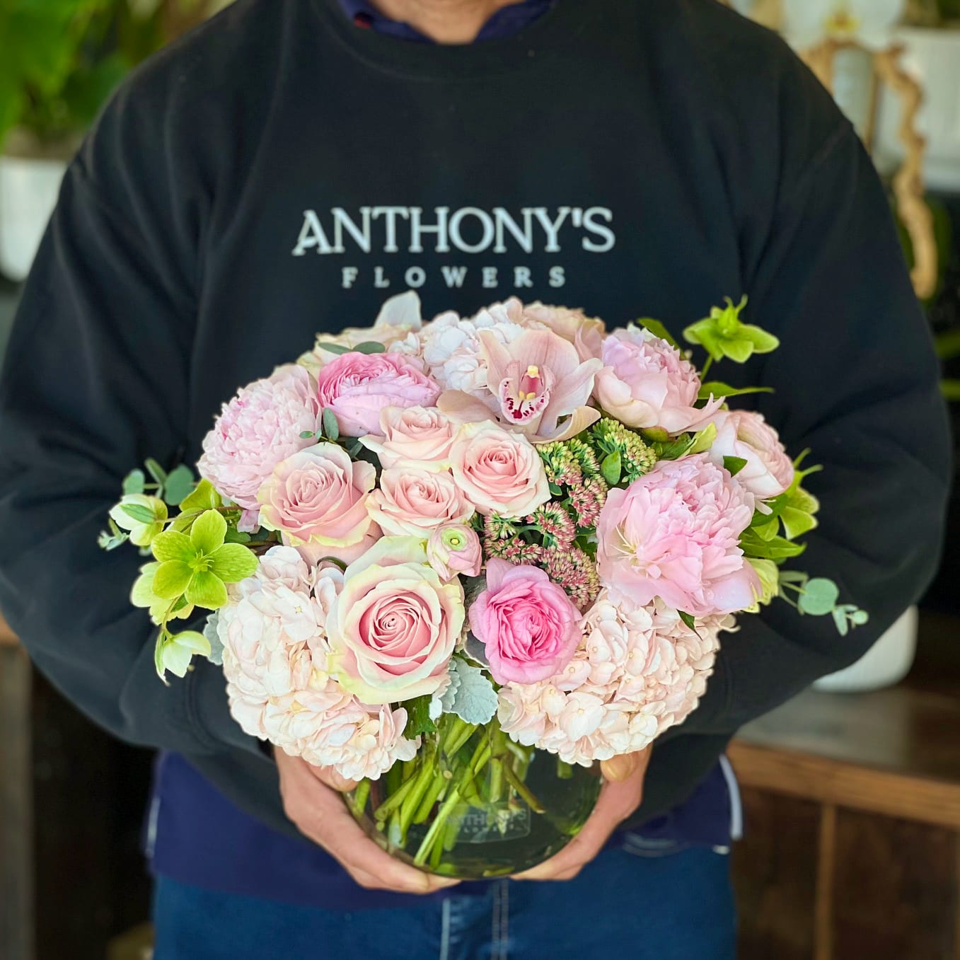 Rosalina - This lush, compact arrangement features a gorgeous collection of pink roses, hydrangeas, peonies, orchids and more feminine flowers in a premium glass cylinder.