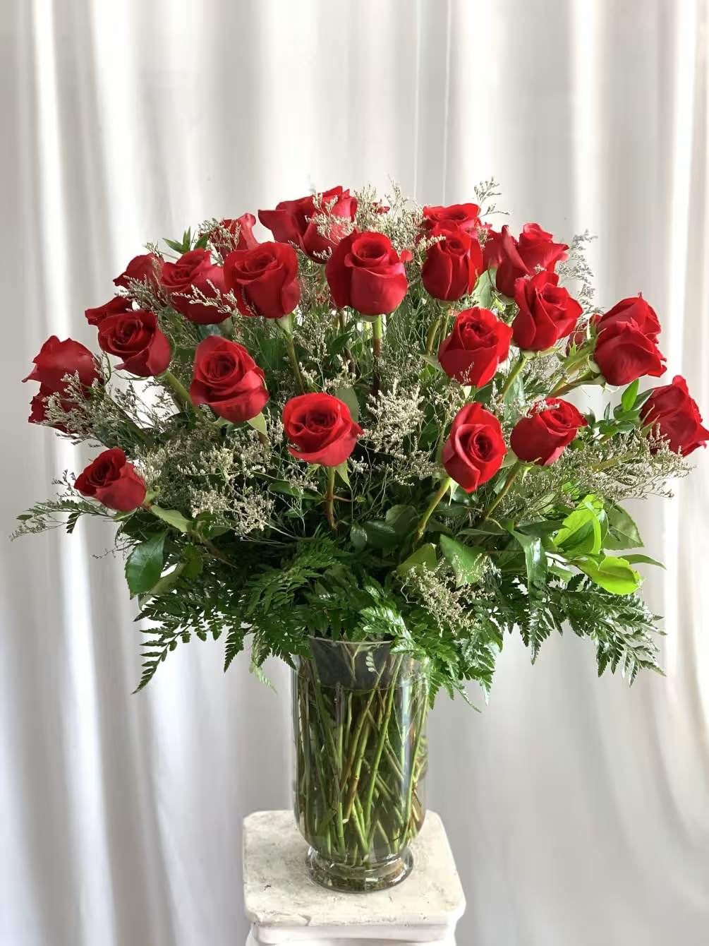Three Dozen Red Roses - Make a bold statement with this beautifully simple design. Three Dozen Red Roses by BloomNation™ is the perfect gift for Valentine's Day, an Anniversary, or when anytime you're feeling romantic.   Arrangement Details: Three dozen red roses in a glass cylinder vase. Also available in mixed colors.  APPROXIMATE DIMENSIONS are 12"D X 12"H 