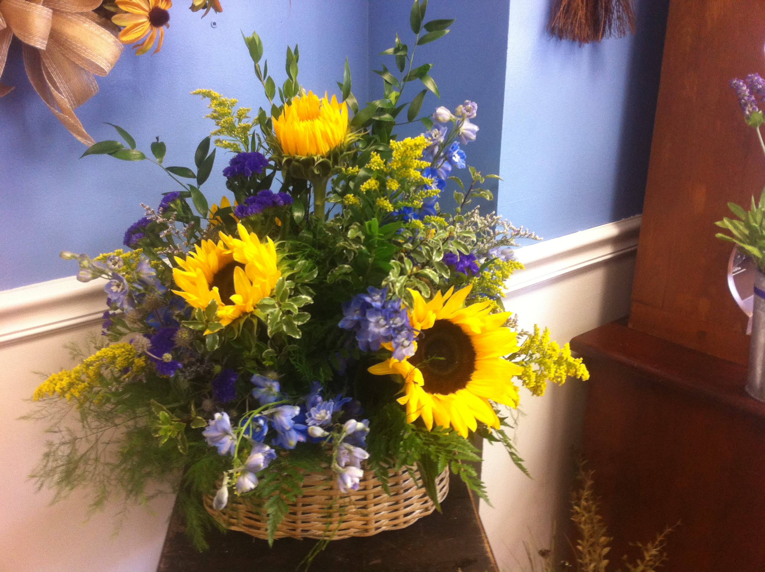Sunflower Fields - Like a late summer walk through the meadow. This beautiful basket arrangement evokes thoughts of sunshine and happiness. 