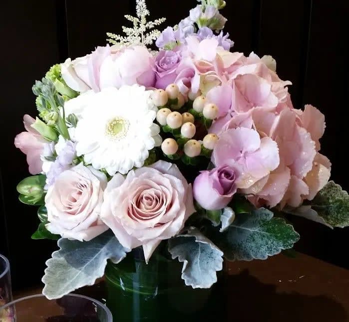 Cotton Candy - A soft mix of blush pink roses, hydrangea, gerpoms and dainty fillers and greens is featured in our Cotton Candy arrangement.  This premium arrangement is so romantic, gorgeous and classy plus it's a perfect arrangement to send for Valentine's Day!  Arrives in either a clear or white 5" cylinder vase with an overall bouquet size of 12" x 12"