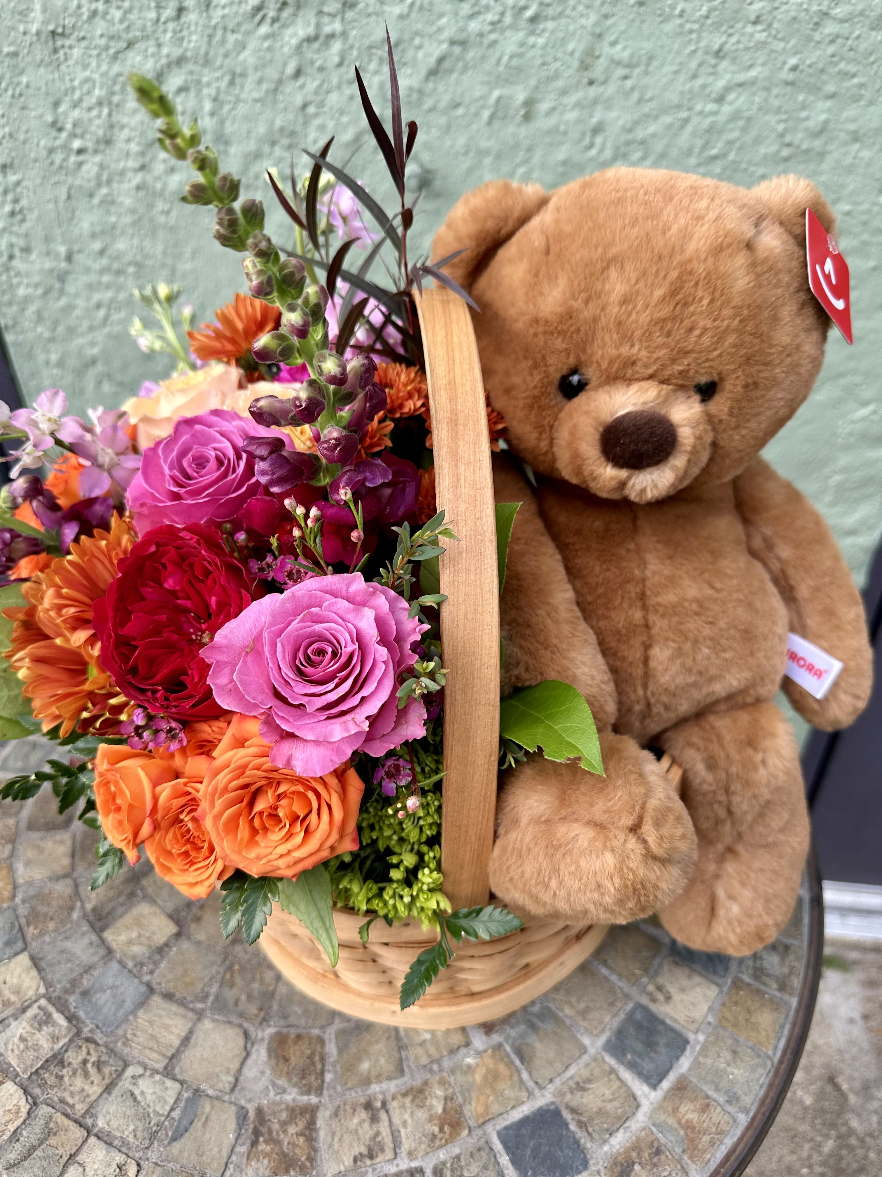 Bear Hug - Lovely duet of beautiful floral arrangement and a super soft bear in a nantucket basket! The floral arrangment can be displayed by itself, once the bear is taken out for hugging.