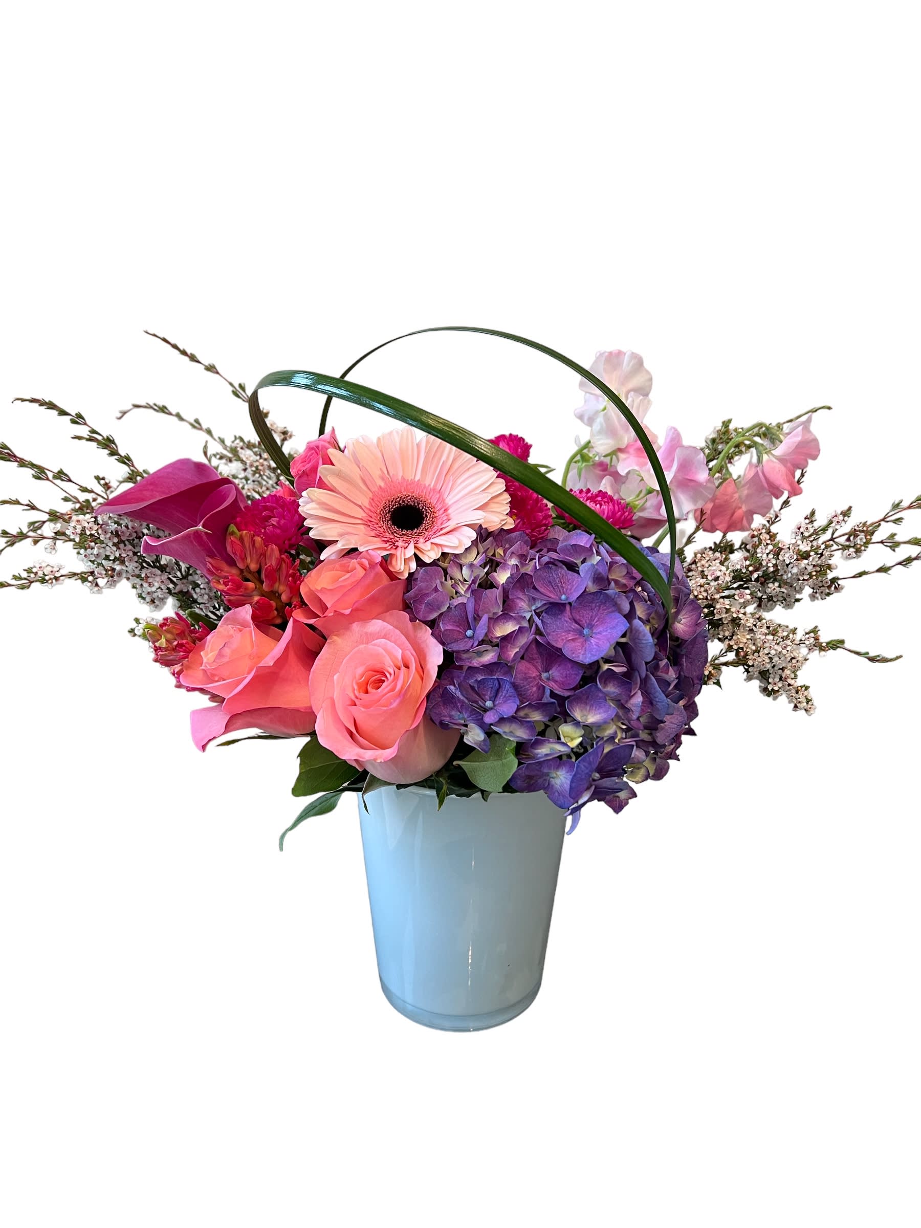 Forever Beautiful  - Purple hydrangea, light pink roses, pink calla lily, sweet pea pink, pink hyacinth, pink gerbera and more designed in a white glass vase.