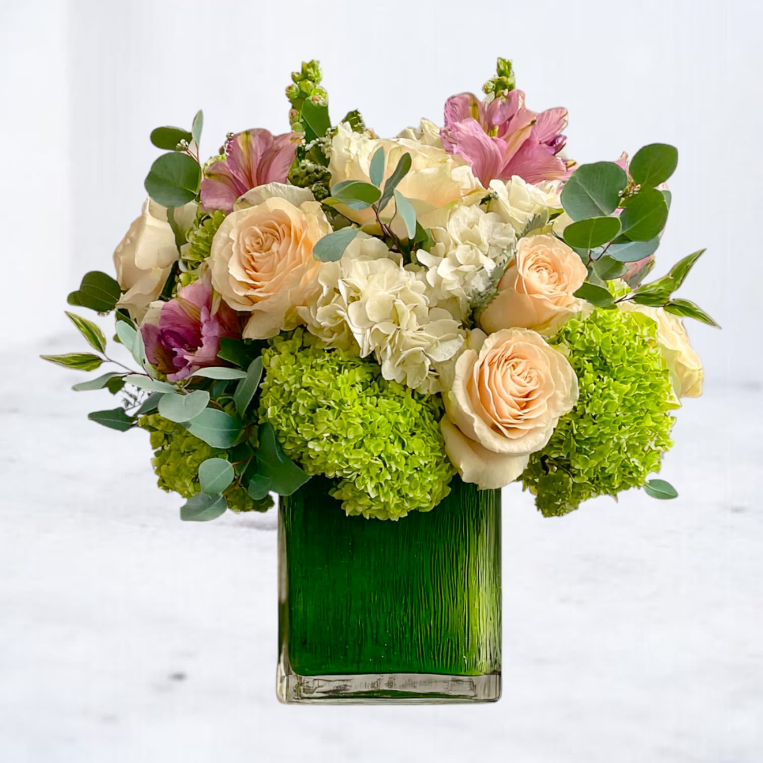 Daybreak - Start the day with warmth and beauty with our Daybreak Bouquet, a radiant mix of peach roses, white &amp; green hydrangeas, pink accents, and soft greenery. Designed in a lined vase, this arrangement exudes effortless elegance, making it the perfect choice for everyday gifting, birthdays, anniversaries, or simply to brighten someone’s home. With its blend of romantic tones and fresh seasonal blooms, Daybreak Bloom brings light and joy to every occasion.  Available for same-day delivery across Houston and surrounding areas.