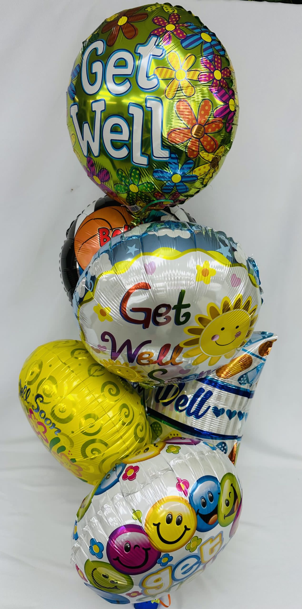 Get Well Mylar Balloon Bouquet - This colorful bouquet of 6 mylar balloons will bring a smile to anyone's face! Balloons styles may be slightly different than pictured.