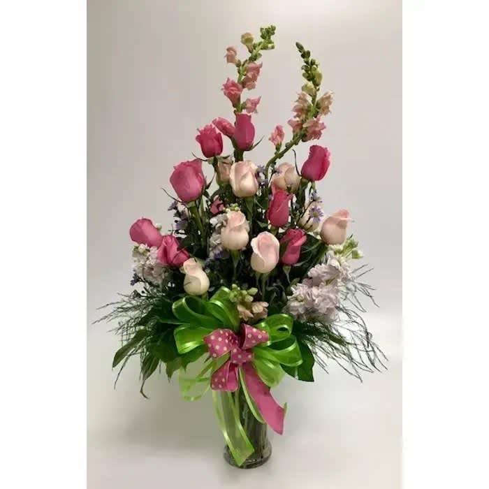 Tickled Pink - A fun, and bright design of two dozen roses, accented with snapdragons, and stock, and topped off with a fun polka dot bow 
