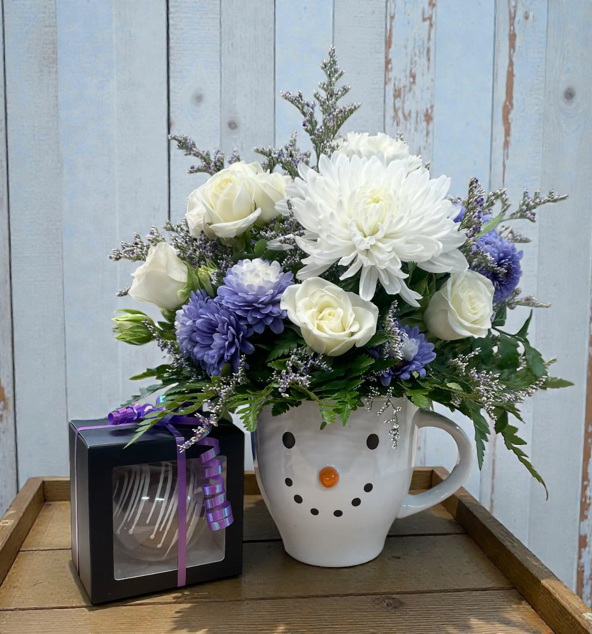 Frosty Blooms &amp; Cozy Cocoa Combo - Enjoy a cozy winter treat with our Frosty Blooms and Hot Cocoa Combo. This Combo includes a cute snowman mug filled with a beautiful flower arrangement paired with a rich hot cocoa bomb.