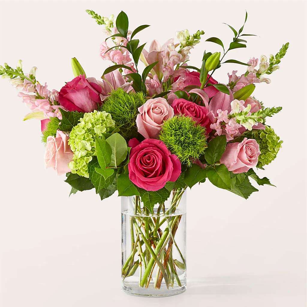 Fit for a Queen Luxury Bouquet - A luxurious gift fit for royalty, this bouquet is bursting with pink and green blooms and is sure to make an entrance.  Details The Deluxe Bouquet is approximately 21"H x 23"W. Designed by florists, ready to display. For long–lasting blooms, replace the water daily. We suggest trimming the stems every couple days. Pet Safety Precautions: This bouquet or plant may include flowers and foliage that are known to be toxic to pets. To keep them safe, be sure to keep this arrangement out of your pet's reach.  Bloom Details Rose Snapdragon Lily Hydrangea