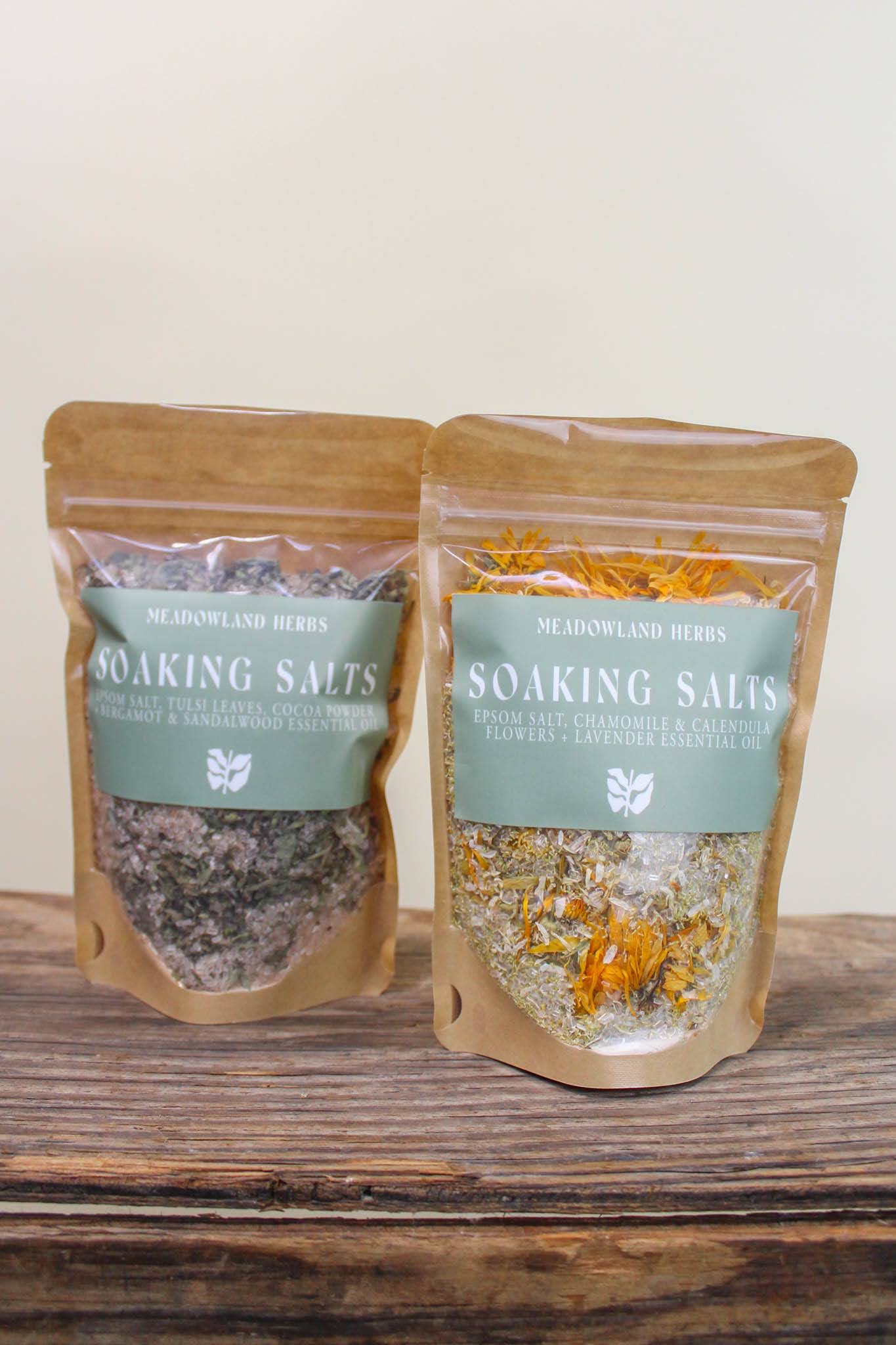 Meadowland Soaking Salts - Local, handcrafted soaking salts made with herbs grown in West Petaluma.   One crafted with Tulsi, cocoa powder + bergamot &amp; sandalwood essential oil an the other with chamomile &amp; calendula flowers + lavender essential oil.   Perfect to soothe &amp; unwind. 