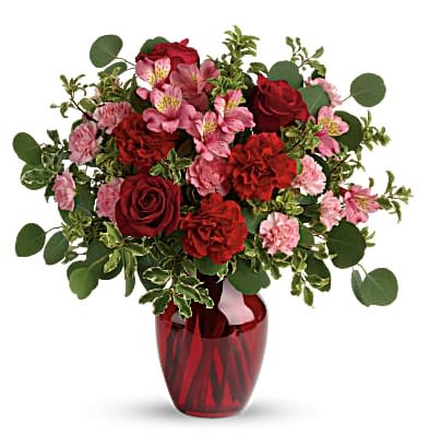 Blooming Belles Bouquet - Tres belle! Ruby red roses and delicate pink alstroemeria are mixed with whimsical greens in a radiant vase for a beautifully blooming gift she'll never forget! - Red roses, pink alstroemeria, red carnations, and pink miniature carnations are accented with silver dollar eucalyptus and pitta negra. - Delivered in a ruby rose vase.