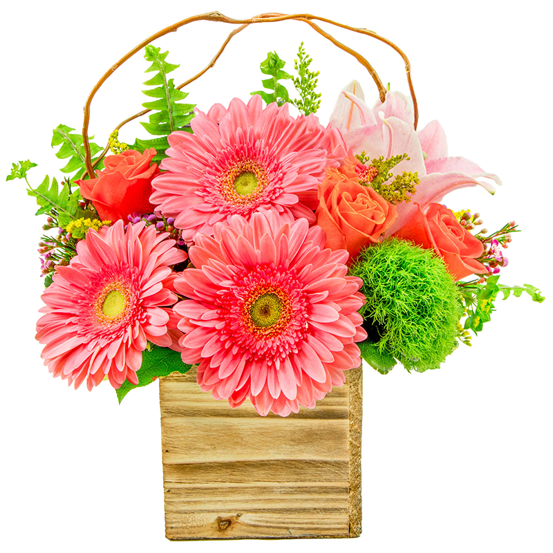 Southern Hospitality - Southern Hospitality is a warm, cheerful arrangement inspired by welcoming charm and easy Southern elegance. Featuring pink gerbera daisies, orange roses, pink lilies, green trick, pink waxflower, yellow solidago, bupleurum, and curly willow, this design is full of lively color, soft texture, and natural movement. Arranged in a rustic wooden container, it feels bright, friendly, and effortlessly inviting—like a smile at the front door.  Perfect for spring celebrations, thank-yous, housewarmings, birthdays, or just because, Southern Hospitality is a heartfelt way to make someone feel truly welcome.