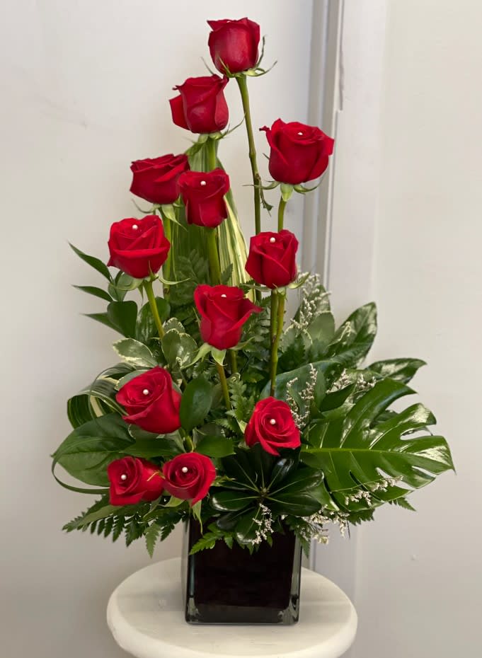 The Shug Bouquet  - When you want to something more than the average dozen of roses! This unique style of red roses will catch everyone's eye and the deluxe option features 15 red roses, because a dozen is so last year!  Dozen (Pictured), 