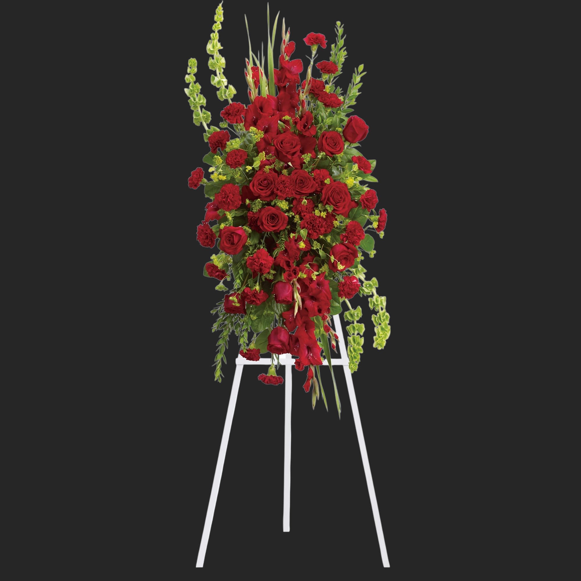 Care and Compassion Spray - Your care and compassion will be appreciated by all who lay eyes on this radiant standing spray. A variety of lovely vibrant red blossoms contrasted by vivid green of bells of Ireland will deliver your heartfelt condolences. Perfectly.  