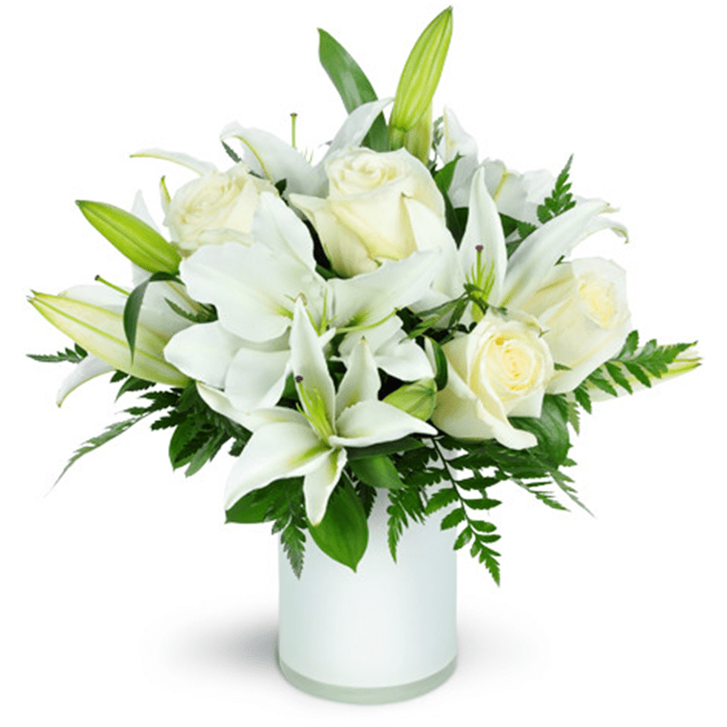 Sweet Notions - Sweet Notions is a quiet, heartfelt arrangement that speaks through softness and simplicity. Designed in soothing shades of white and cream, it blends elegant roses and graceful lilies with fresh green accents for a look that feels calm, comforting, and sincere. There’s a gentle beauty to this piece—nothing loud, nothing rushed—just thoughtful intention in every bloom.  Often chosen for sympathy, remembrance, or moments when words feel hard to find, Sweet Notions is also a lovely way to say I’m thinking of you or I’m here in the most understated way. Arranged in a clean white vase, it feels timeless, peaceful, and deeply reassuring.