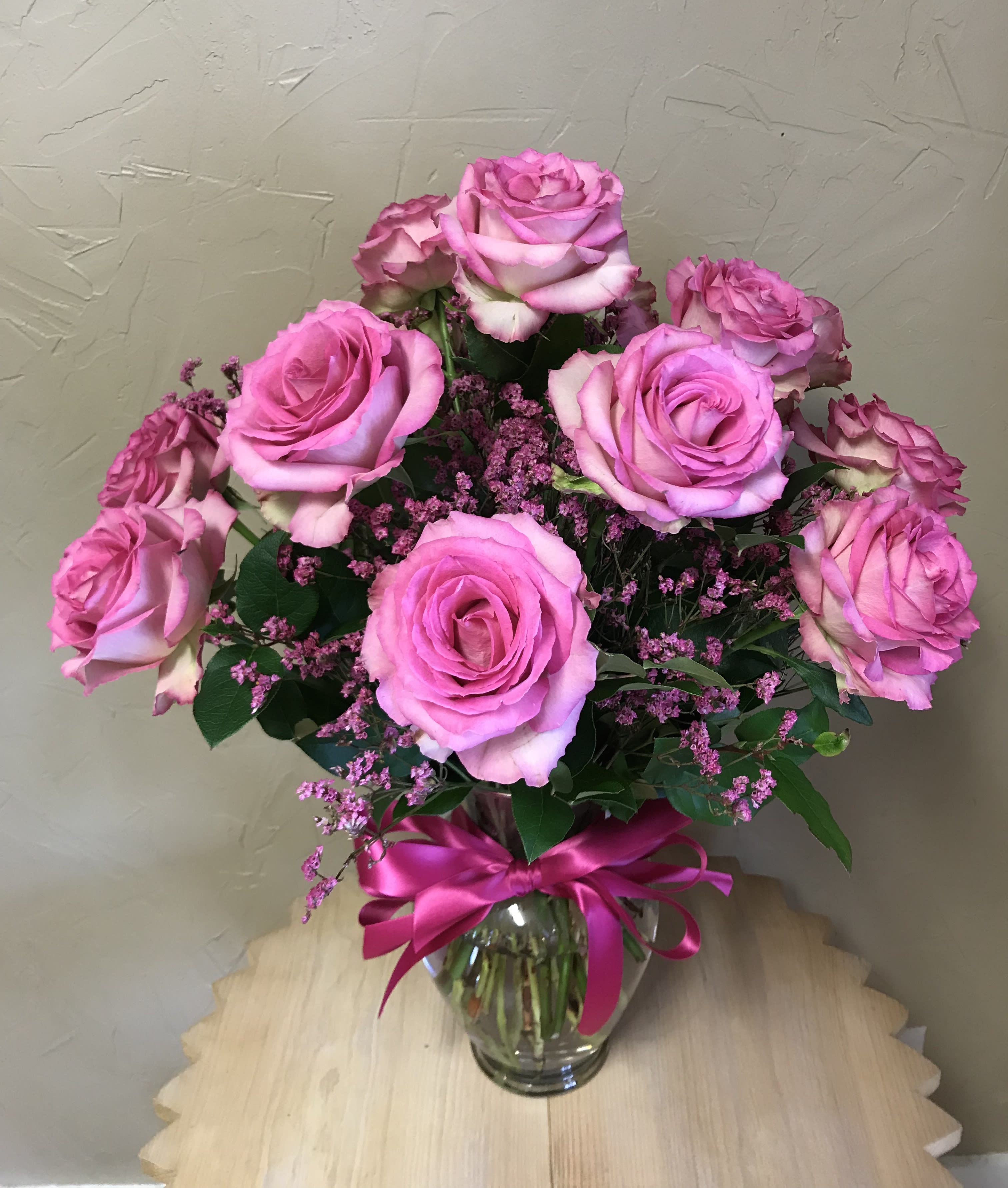 Dozen Pink Roses - One dozen pink roses matched perfectly with a coordinated bow, filler flowers and greenery~ expect a big kiss for this delivery! Designer's choice on flowers and vase