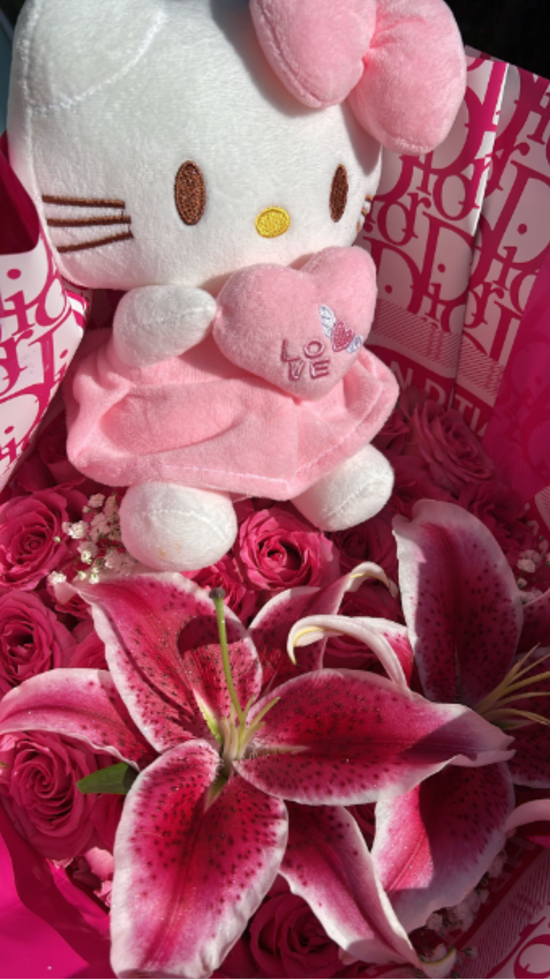 Hello Kitty Ramo Buchón (25 Rose count)  - A bouquet featuring 50 sweet unique signature hot pink roses, fresh pink oriental lilies, and a Hello Kitty plush toy included. 