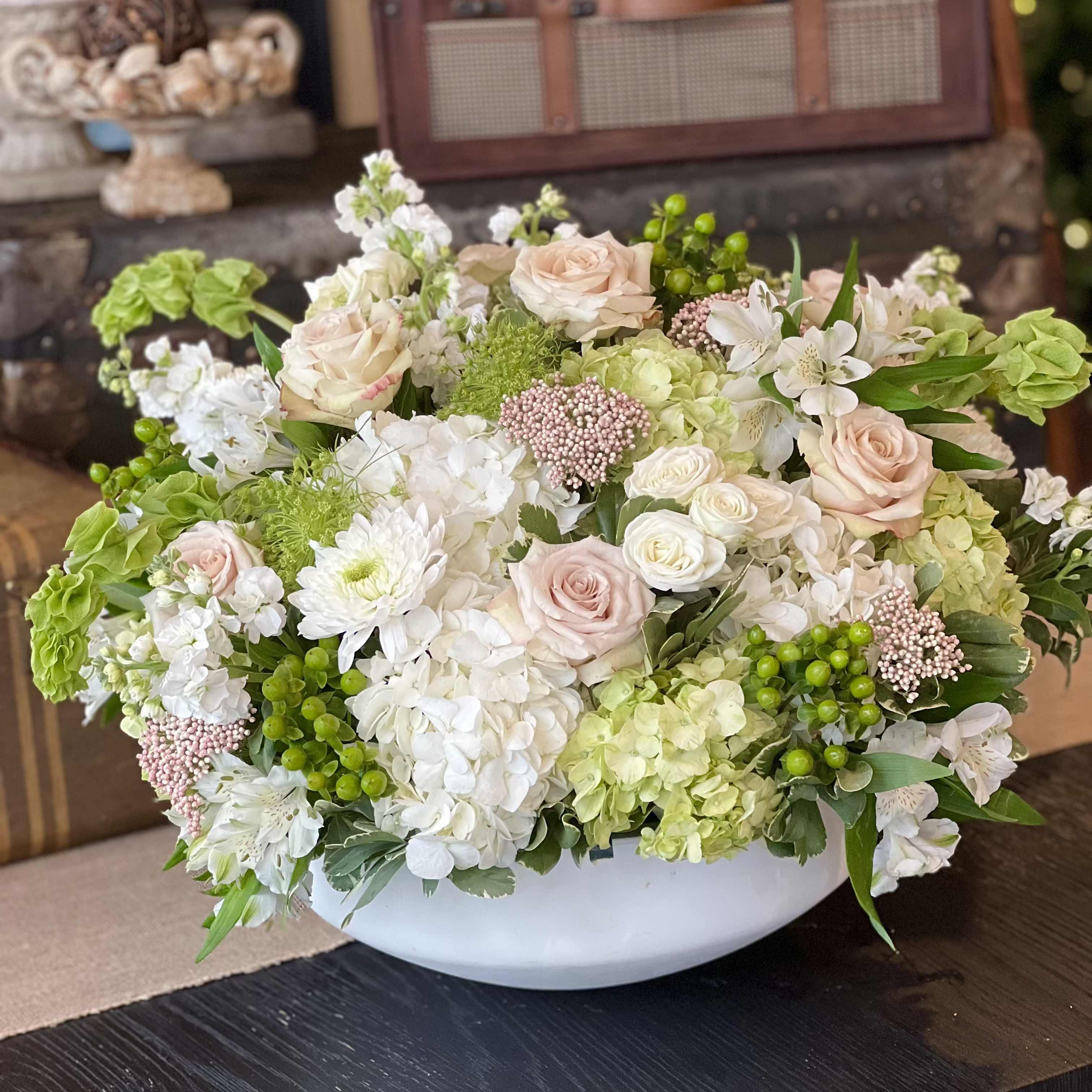 Serenity In Bloom - Each arrangement is custom designed, using seasonal, best-of-day blooms. The image shown represents its size, style and temperament, however certain flowers may be substituted to achieve the best quality and longevity for your florals.
