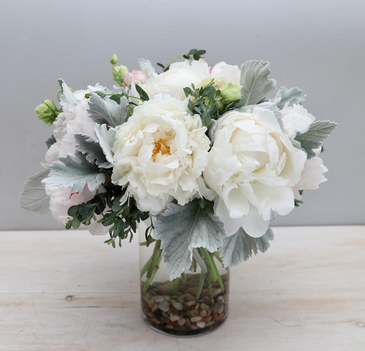 Lovely White Peonies  - My Glendale Florist  - This beautiful white peony arrangement in a glass vase exudes elegance and sophistication. The stunning blooms of the white peonies are gracefully arranged, showcasing their striking beauty against the clear glass vase. Overall height and width for the standard size is 12''x12''. Each upgrade is about 50% larger. 