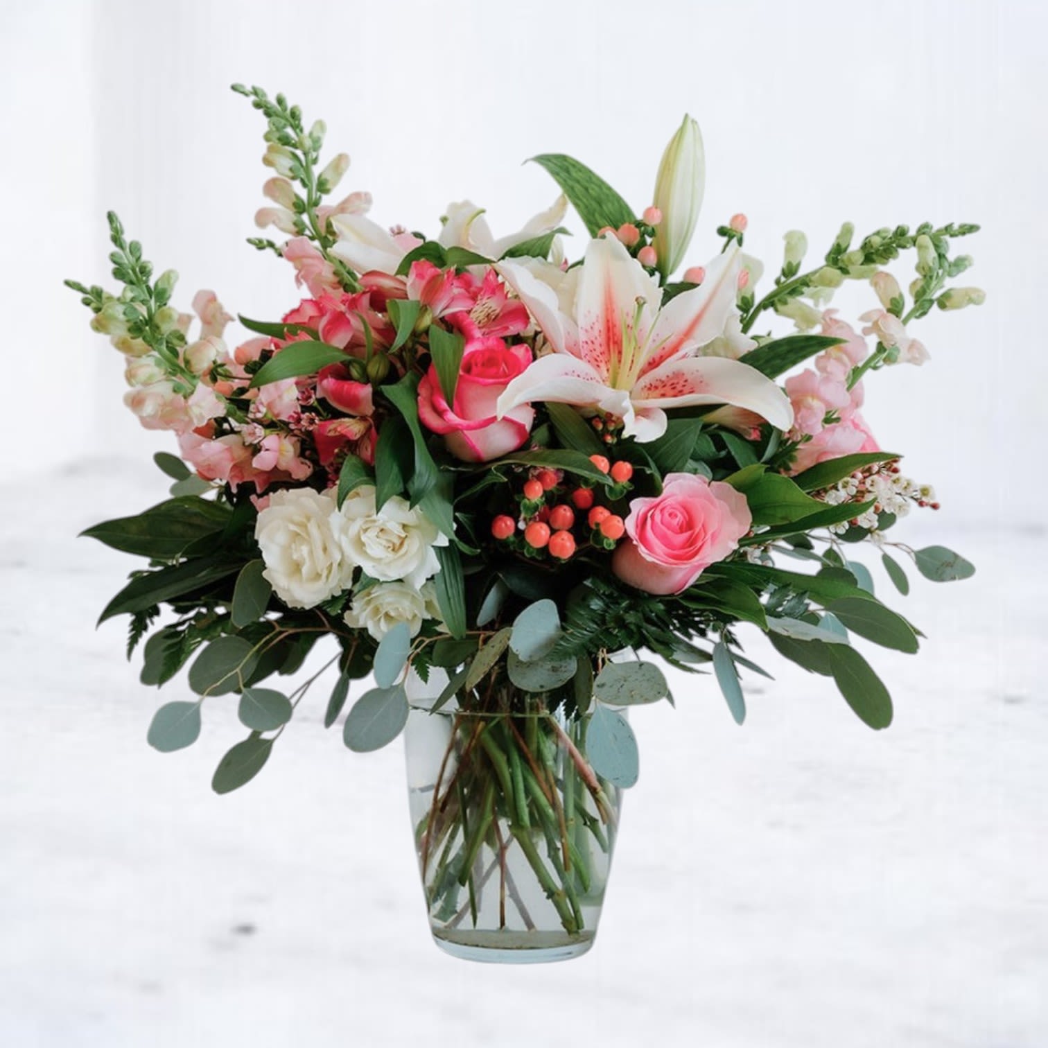 Lily Crush - Bold, romantic, and playfully sweet, Lily Crush is a floral love note with a little edge. Featuring fragrant stargazer lilies, hot pink roses, blush snapdragons, alstroemeria, creamy spray roses, and pink accents, this bouquet is lush, layered, and impossible to ignore. Overflowing with greenery and heart, it’s made for making moments more memorable.  Whether you're celebrating a special occasion, surprising someone just because, or sending a romantic gesture, Lily Crush is available for same-day flower delivery in Houston and surrounding areas.