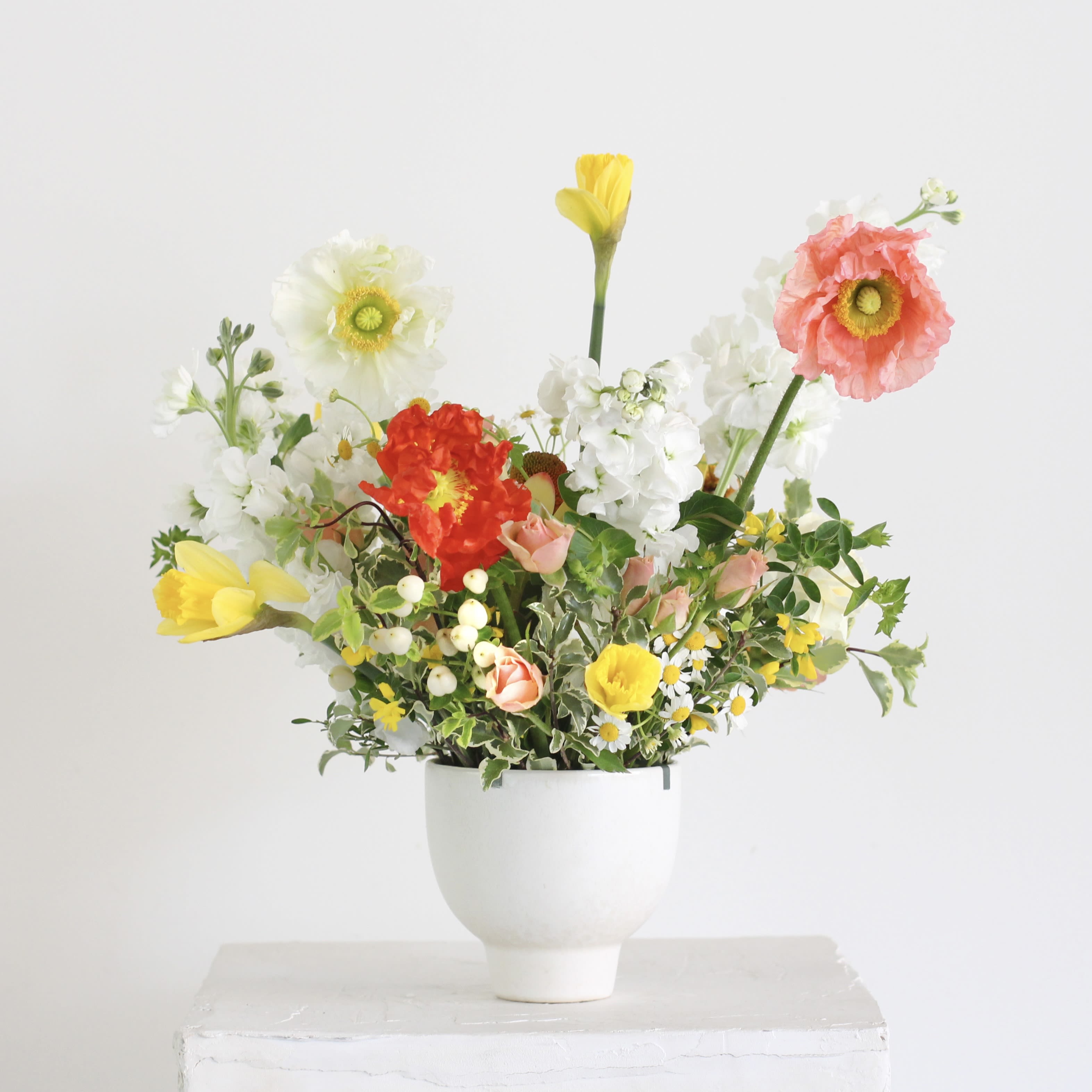 The Golden - Celebrate the ever changing beauty of our beloved hometown with The Golden, an accent table arrangement designed to brighten your space! This rotating selection of seasonal flowers features stunning blooms in shades of gold, pink, orange, and yellow, bringing warmth and joy to any room or occasion.  APPX 10x10  Delivery Policy: At Middlemist, we aim to make every delivery seamless and delightful. It is the sender’s responsibility to ensure the recipient is available to accept delivery between 3–5pm on the scheduled date and that the delivery address is accurate. We will send a text notification to the recipient on the day of delivery. If no one is available to receive the order, it will be returned to the shop and may be picked up or redelivered for an additional delivery fee. If a recipient requests the order be left unattended, we cannot guarantee the condition of the flowers or plants, and no refunds will be issued once an order is left outside.