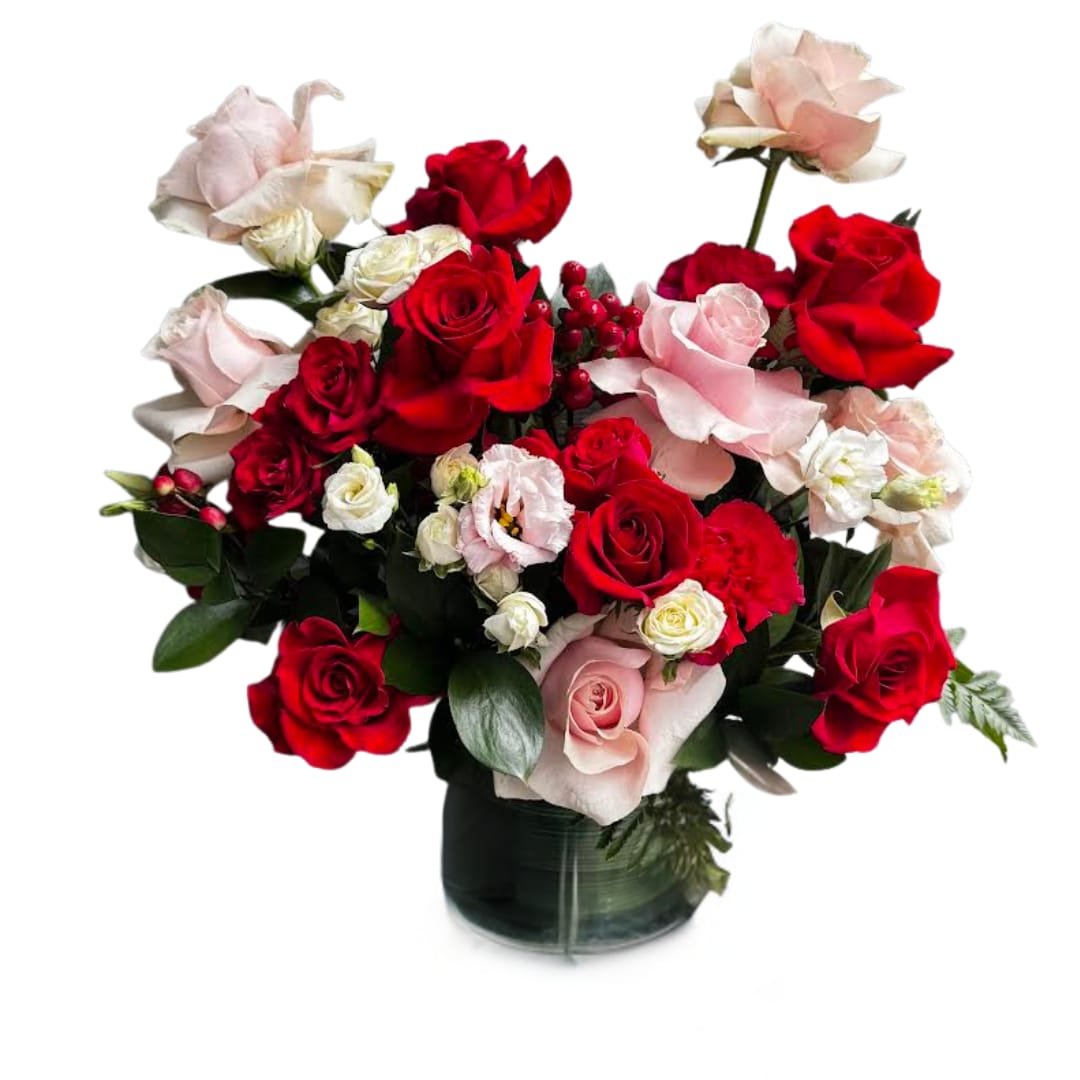 Red Velvet - A romantic, lush mix of red and blush roses with delicate white accents, seasonal texture, and rich greenery — designed in a modern glass vase. Bold + soft at the same time… basically the floral version of “I’m obsessed with you.”