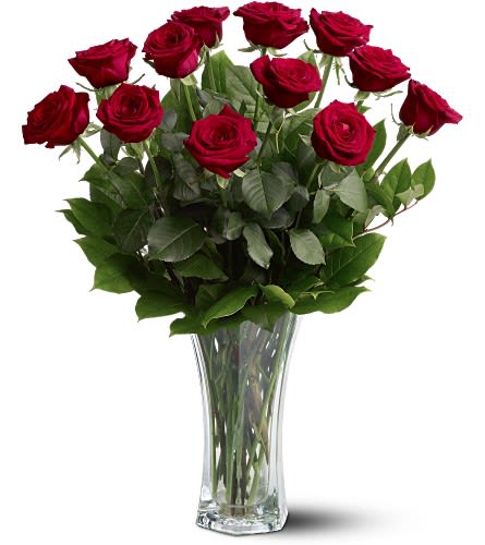 Darling Dozen - Twelve premium red roses are beautifully arranged with lush greenery in a clear glass vase for a timeless and unforgettable presentation. Elegant, romantic, and always in style, Darling Dozen is the ultimate expression of love—perfect for anniversaries, Valentine’s Day, proposals, or any occasion that calls for a grand romantic gesture.