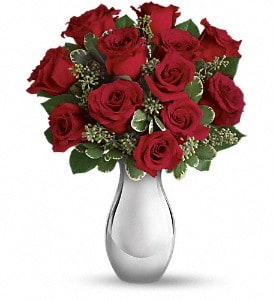 True Romance - A timeless arrangement of 12 rich red roses is elegantly gathered with fresh seasonal greenery in a graceful clear glass vase. Simple, classic, and undeniably romantic, True Romance is the perfect expression of love—ideal for anniversaries, Valentine’s Day, proposals, or any moment meant to celebrate deep connection and heartfelt emotion.