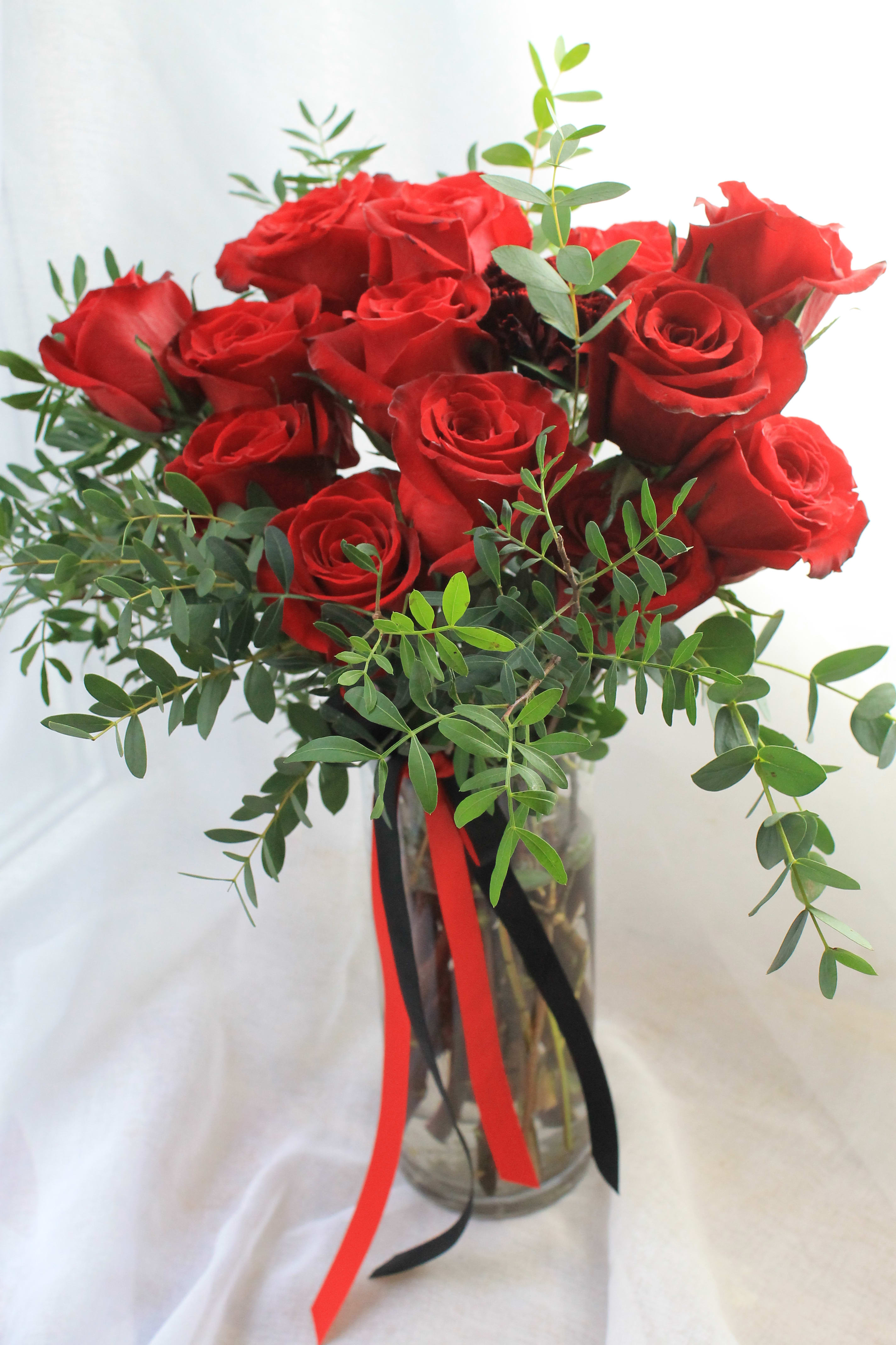 Classic Rose (One Dozen) - 10 inch glass vase with dozen roses and greenery. Perfect gift for Valentines Day! As the premier flower shop in New York, we are committed to delivering not just flowers, but a luxurious experience. With our promise of same-day delivery across Manhattan, Queens, Bronx, Brooklyn, Staten Island, and Westchester counties, your gesture of love or gratitude will arrive fresh and beautiful, exactly when it needs to. Each bouquet is curated from the finest, most opulent flowers, crafted into unique and whimsical designs that stand out from the mundane. Choose to send a masterpiece that speaks volumes, because nothing says it better than the best flowers from the best flower shop in New York.  Best florist, nyc, local florist, send flowers, flower delivery, same day delivery, florist around me, flower shop, best flower shop,flowers, flower delivery, peony, peonies, same day flower delivery,  wedding florist, best florist nyc, new york city florist, florist near me, manhattan florist,  brooklyn florist 