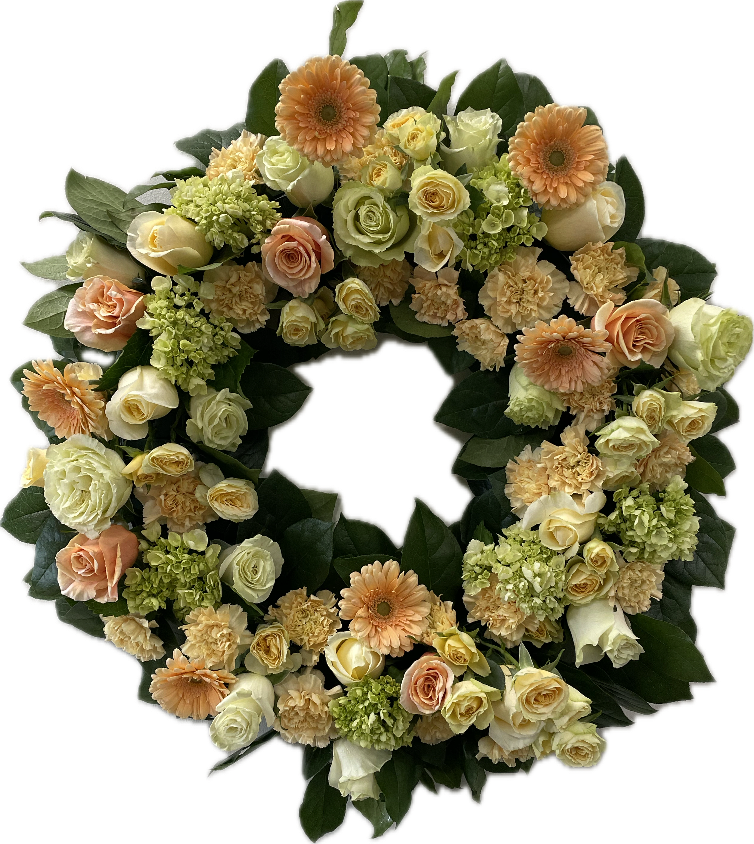 Sweet Peach Comfort Easel Wreath - Sweet Peach Comfort is a warm collection of pastel shades of peach and yellow with touches of soft white. These pieces bring a sense of peace and solace, honoring a life with grace and beauty. The blooms featured may include creamy shades of peach and yellow in roses and spray roses, along with mini green hydrangeas, gerber daisies, and carnations, or our freshest seasonally available blooms. This is a wreath designed to be displayed upright on an easel at the services. 