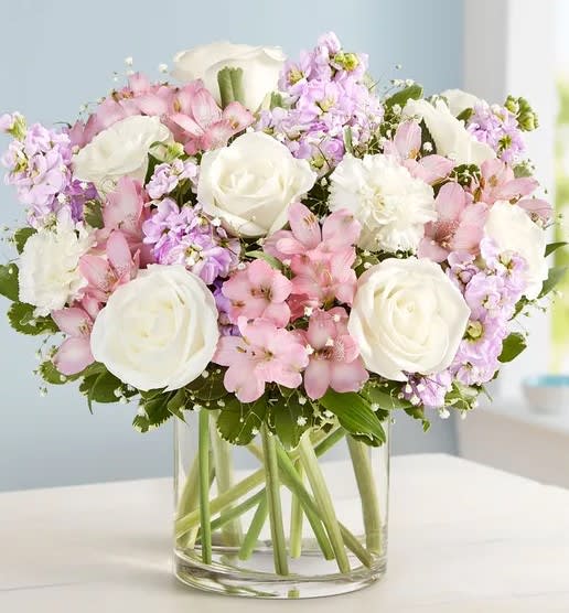 Serene Garden - A classic and calming arrangement of blush, lavender, and white, designed in a compact style in a low glass vase. 