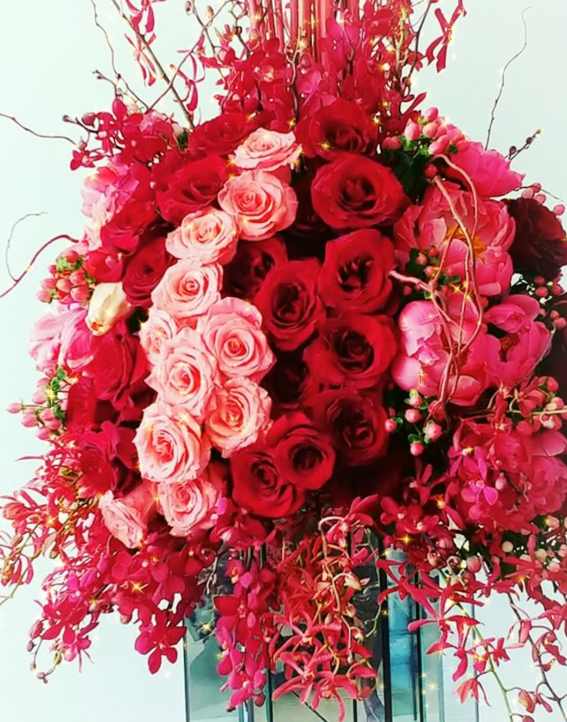 The big darling - Lush vibrant botanical/modern design of peonies, orchids, roses, berries on a large cylinder glass container. 