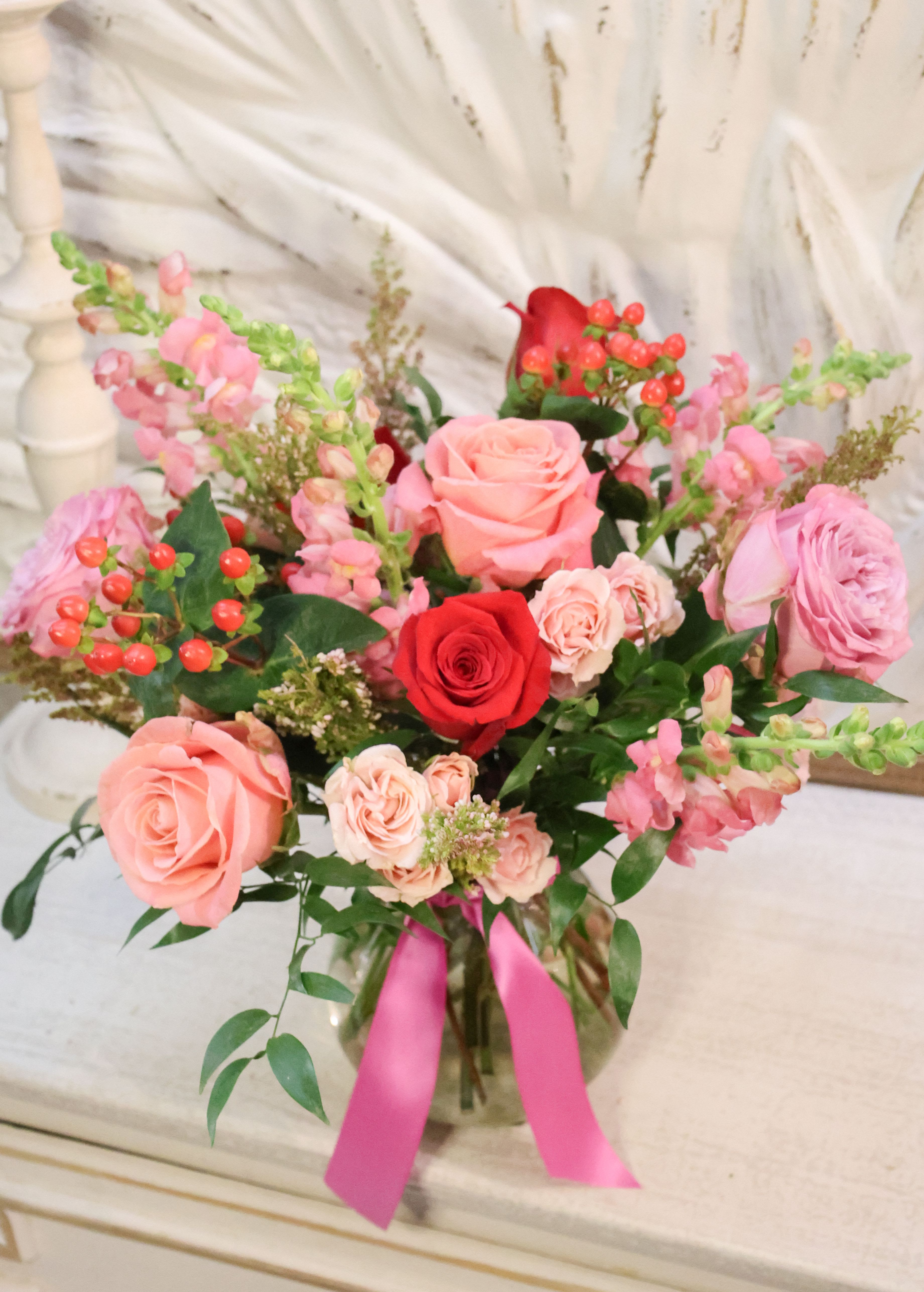 Pink Berry - A Sweet mix of pink, red and lavender roses, berries, snapdragons and fluffy greens in glass vase  stands about 14" tall and 12" wide