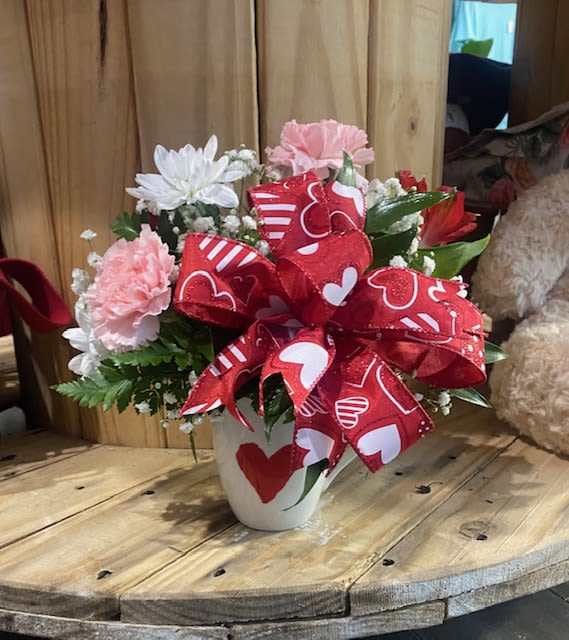 Valentine Mug Arrangement - Petite Arrangement in a Valentine Mug perfect for the Coffee Lover's in your life! Flowers in Reds, Pinks and Whites for the Holiday!