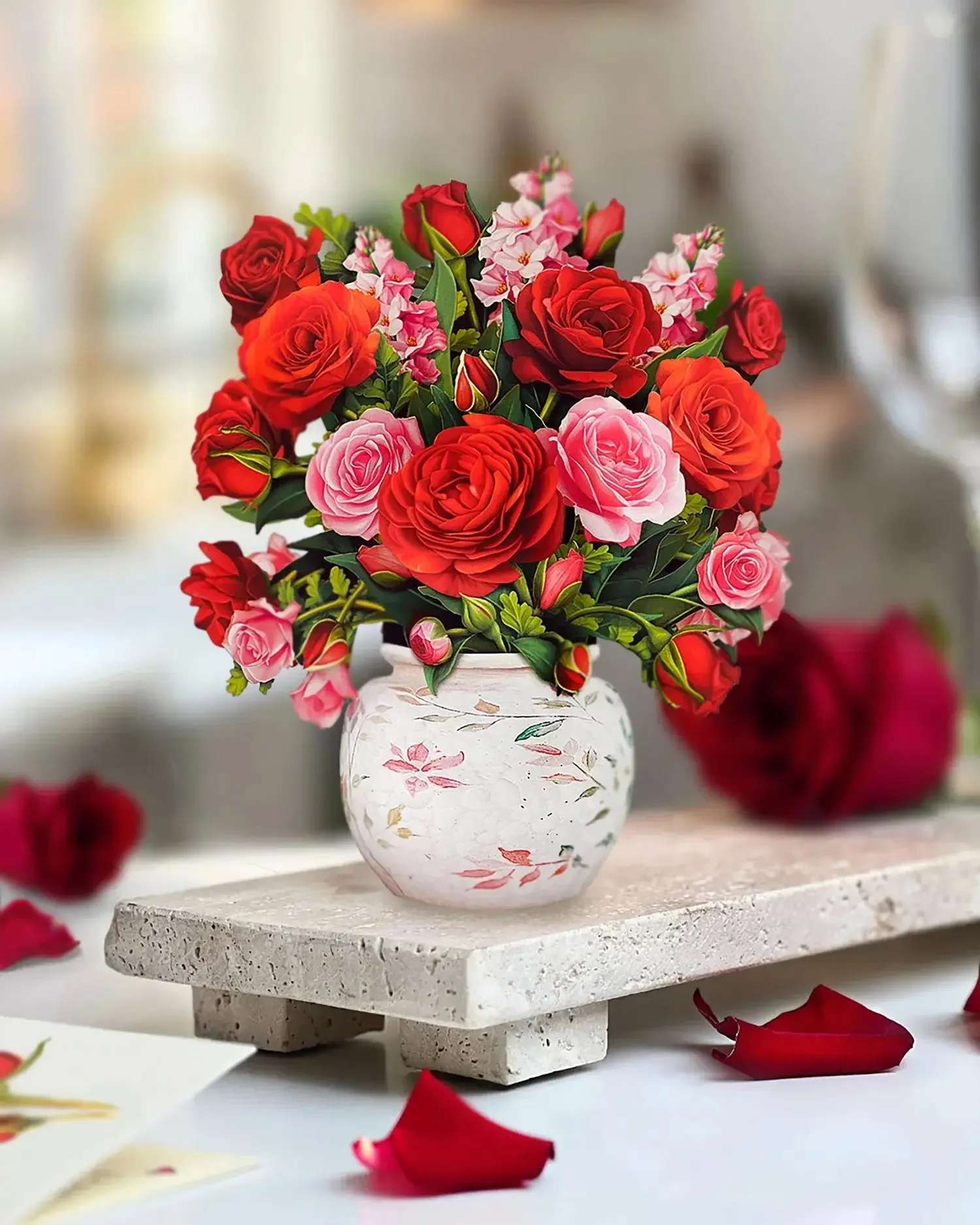 Mini Blooming Roses Pop-Up Card - Effortlessly charming, the Mini Blooming Rose Bouquet is a burst of garden roses and snapdragons, shimmering in soft shades of pink and red—a little pop of color that’s big on beauty. This mini rose pop-up card and bouquet is a perfect mini romantic card for anniversaries, birthdays, or just because. Nestled in an ornate watercolor crackle vase, it’s a small floral pop-up that makes a big impression. Includes a vibrant envelope and matching blank notecard, making it easy to mail with just a few forever stamps. A timeless gesture, this card is sure to brighten anyone’s day.