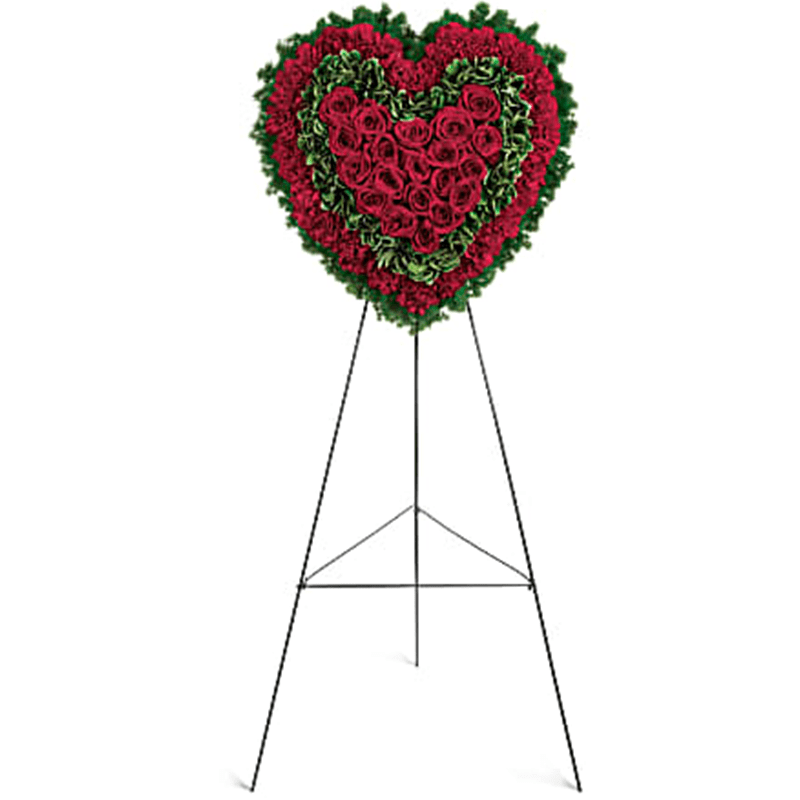 Majestic Heart Standing Spray - Speak from your heart. This majestic funeral display is a charming, heartfelt way to express your love, composed of sympathy red roses and carnations with variegated pittosporum and ming fern. Red carnations, red roses, variegated pittosporum and ming fern are arranged into a touching heart design that's presented ona wire easel. Orientation: One-Sided